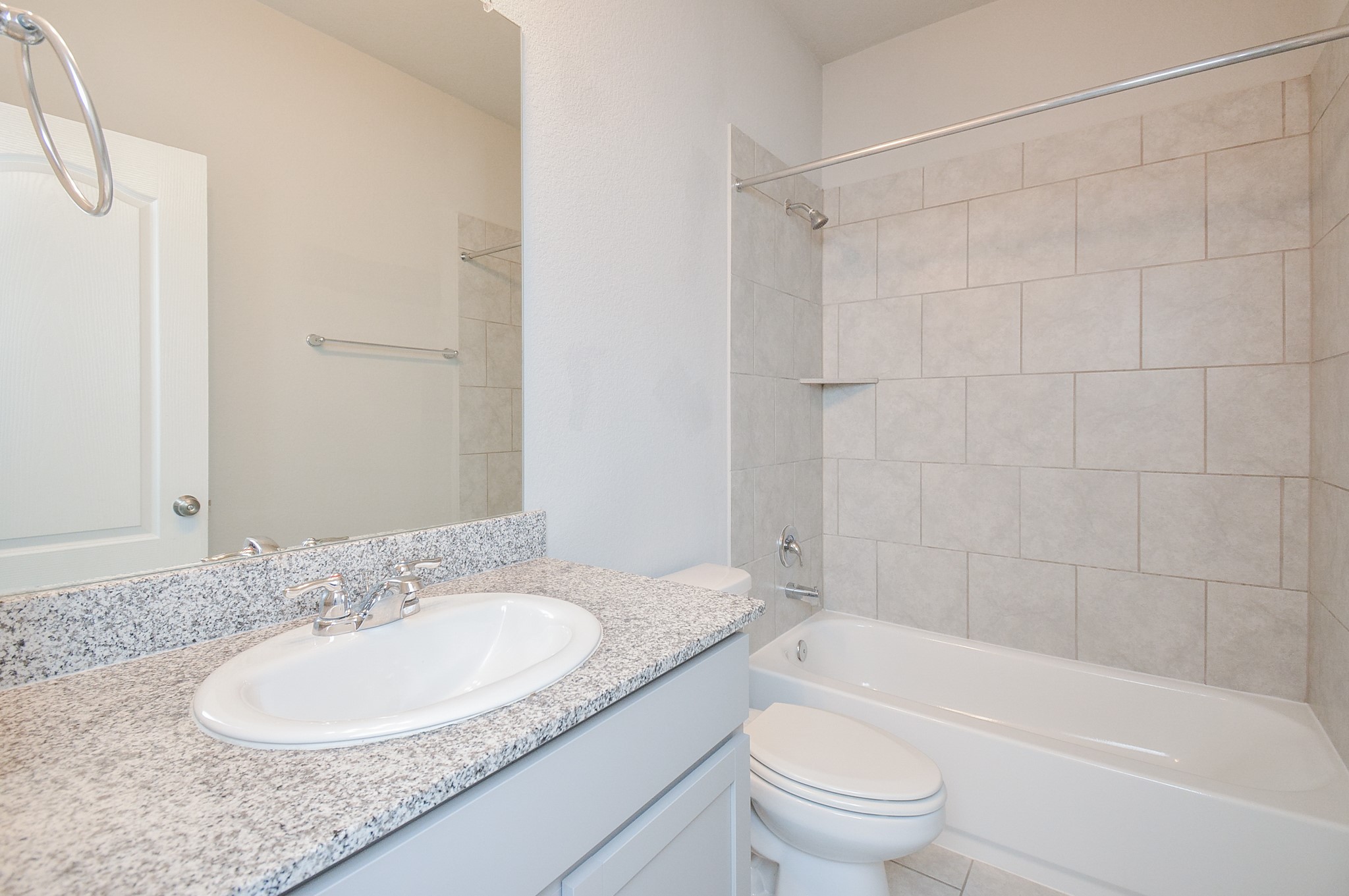 Don't you love the repeated use of giant tile in the combined shower/bathtub in the 2nd full bathroom?