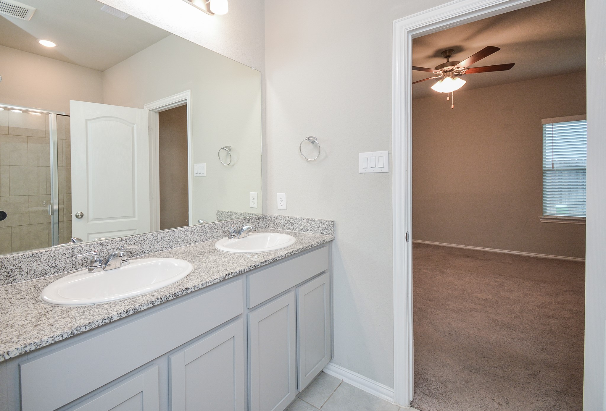Here's the view from the primary bath into the bedroom.