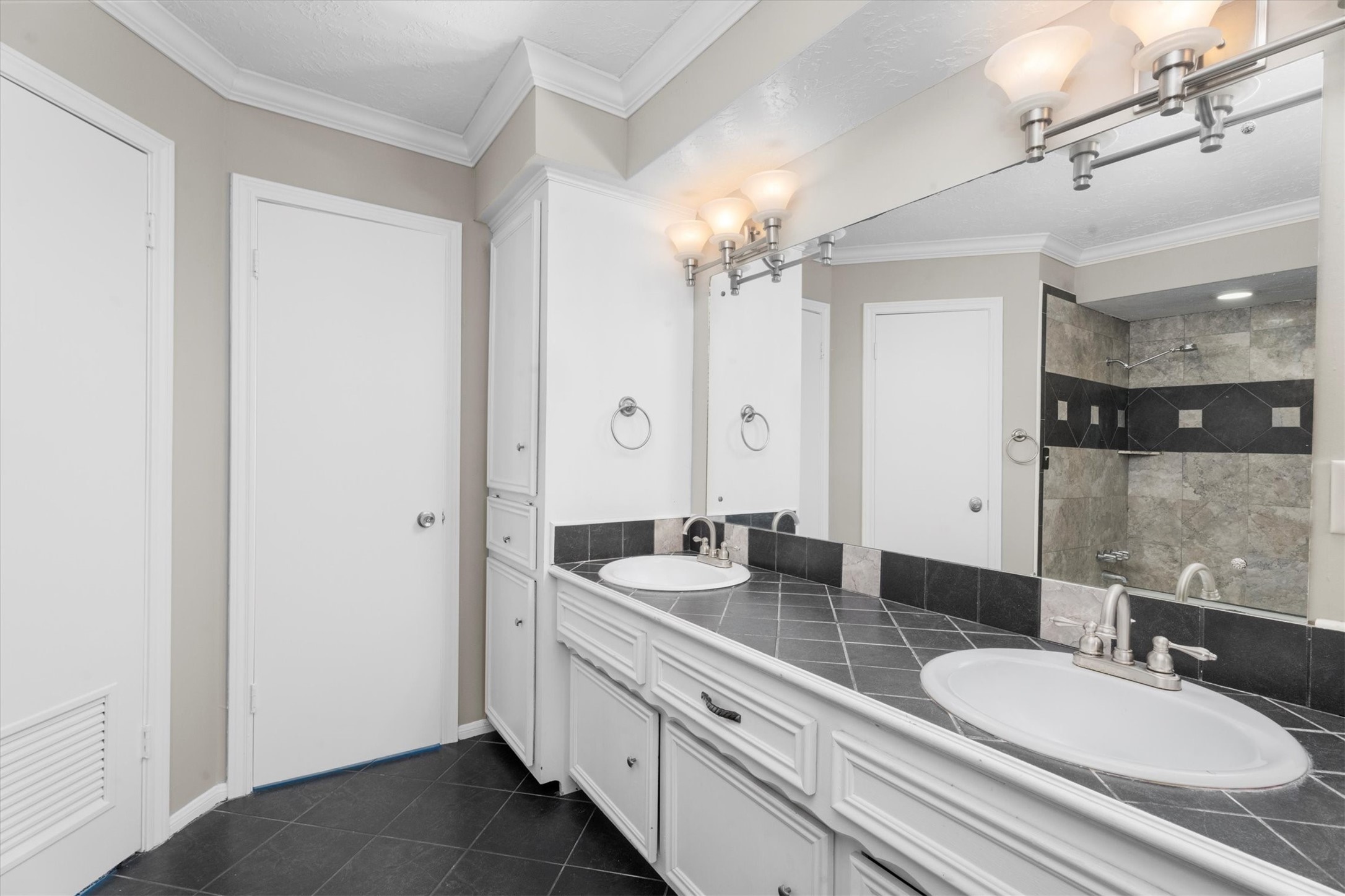 Double vanities in Primary Bath with updated lighting, and fixtures