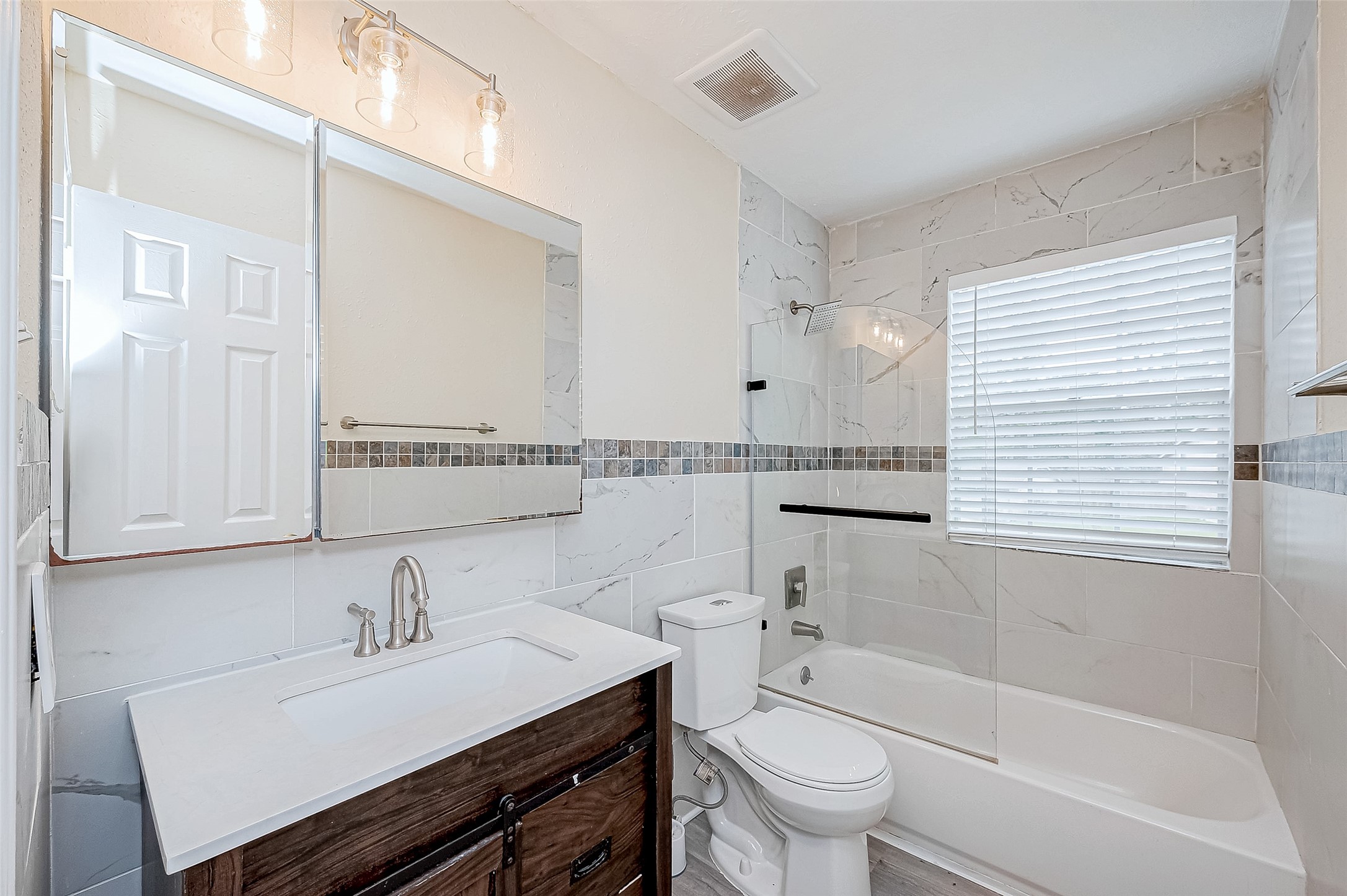 The full bathroom combines functionality with style, featuring a tub/shower combination and a sleek vanity with undercabinet storage. Its efficient layout ensures convenience for daily use.