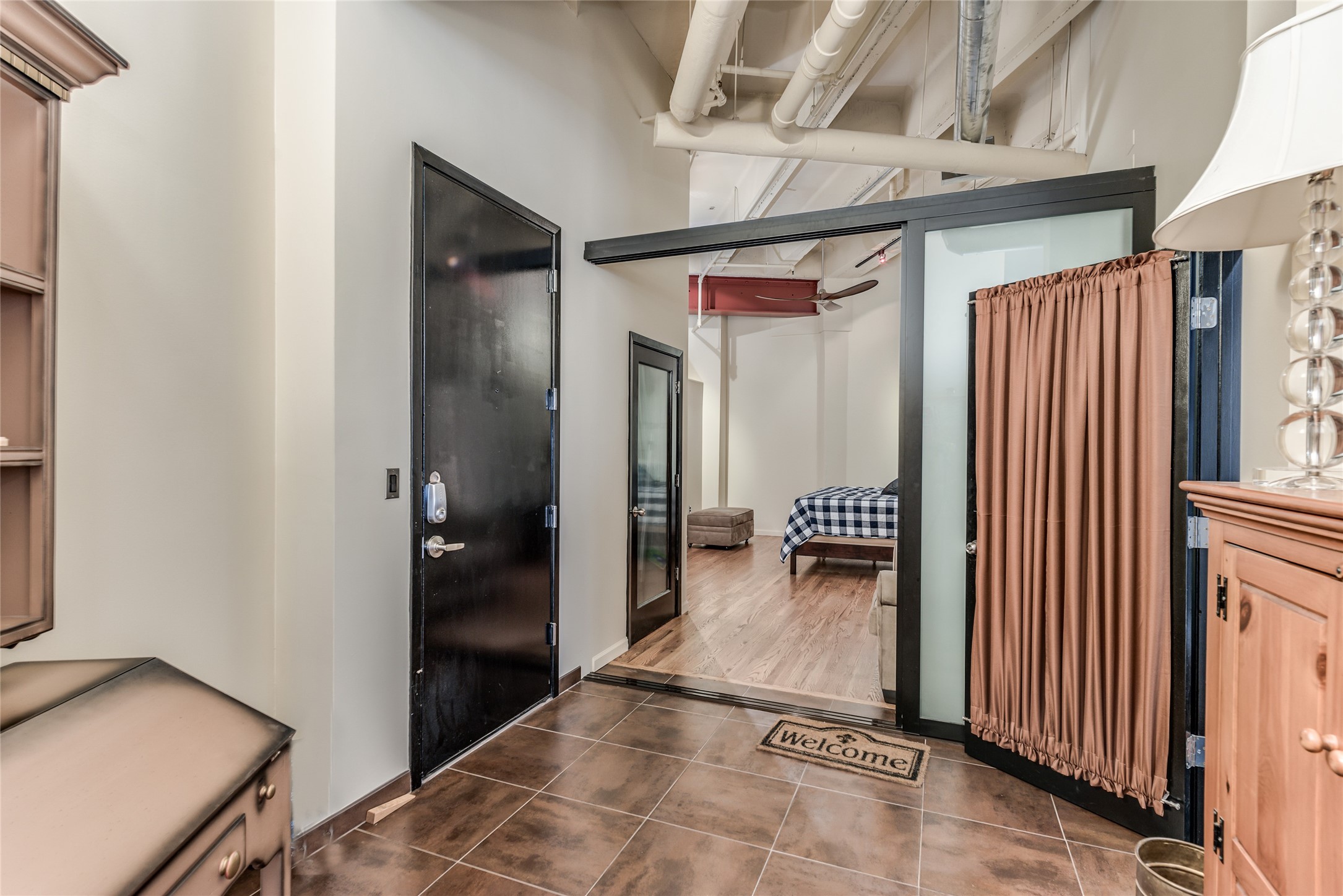 This photo shows a cozy entrance with tiled flooring, leading to bedroom and living area.