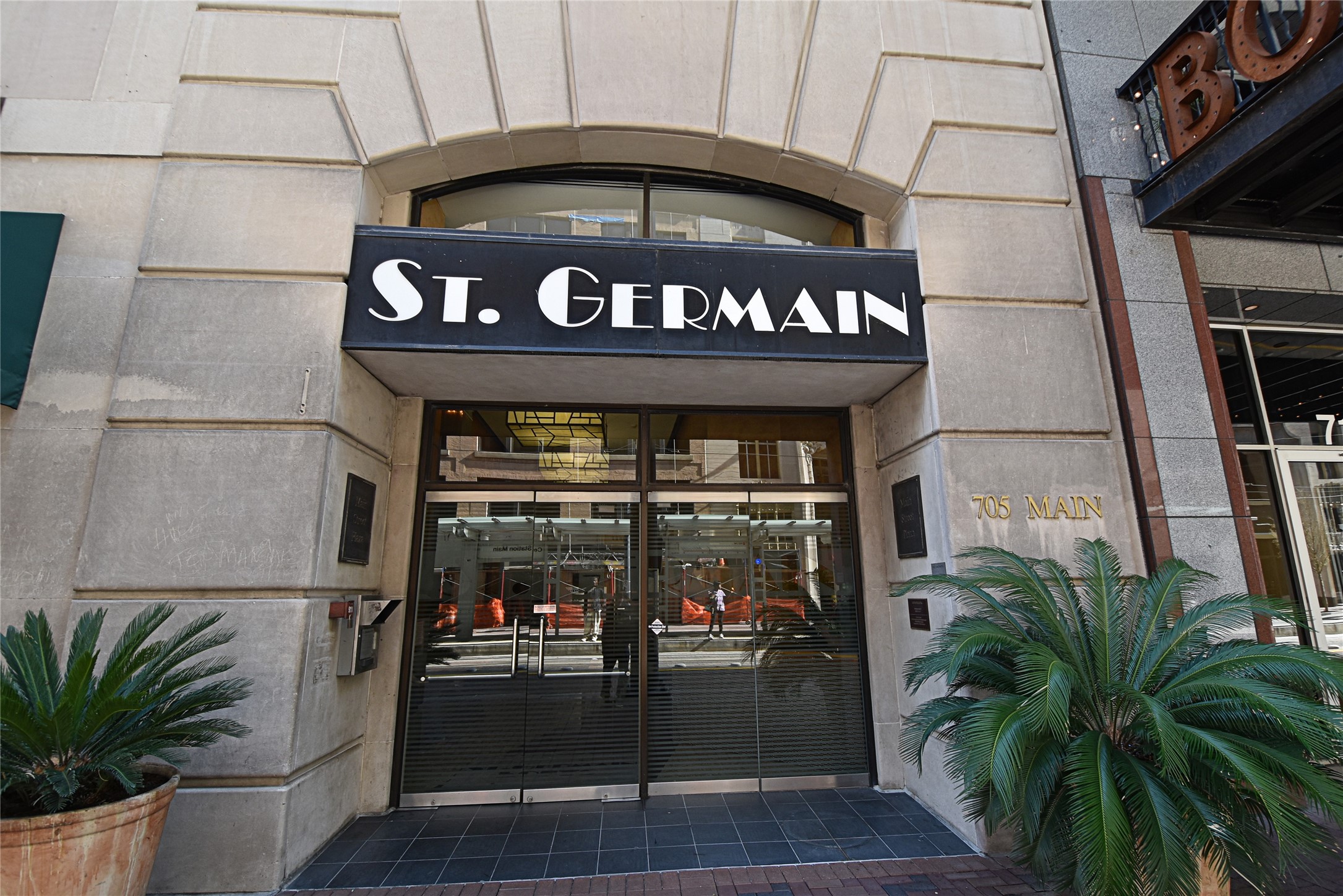 Tthe entrance to the St. Germain building, featuring a modern facade with large glass doors and a prominent sign.