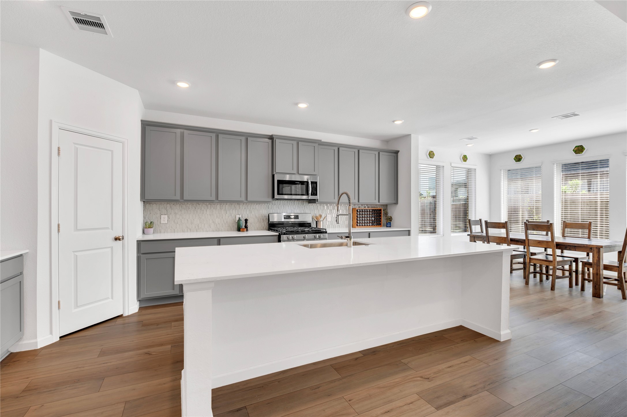 kitchen with beautiful natural light, quartz countertops, and a farmhouse style sink!