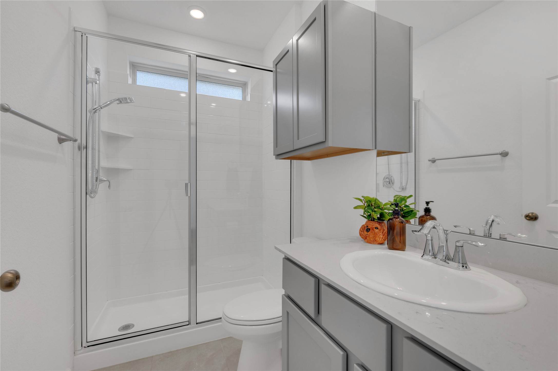 Mother-in-law bathroom with adjustable shower head, amazing water pressure, plenty of cabinet space, and quartz countertops!