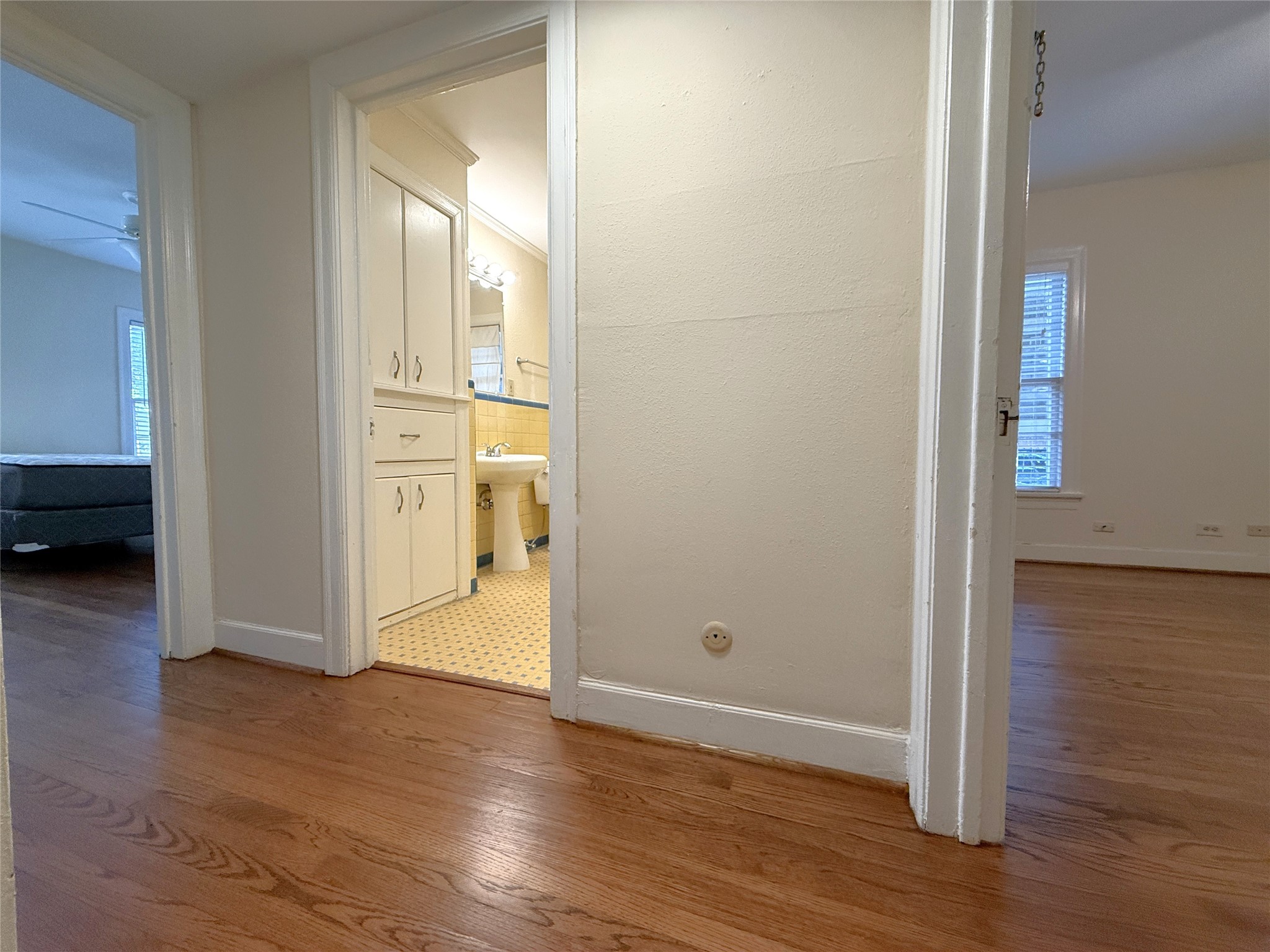 The primary and secondary bedrooms do not share a wall. Between the primary and secondary bedroom is the hallway bathroom.