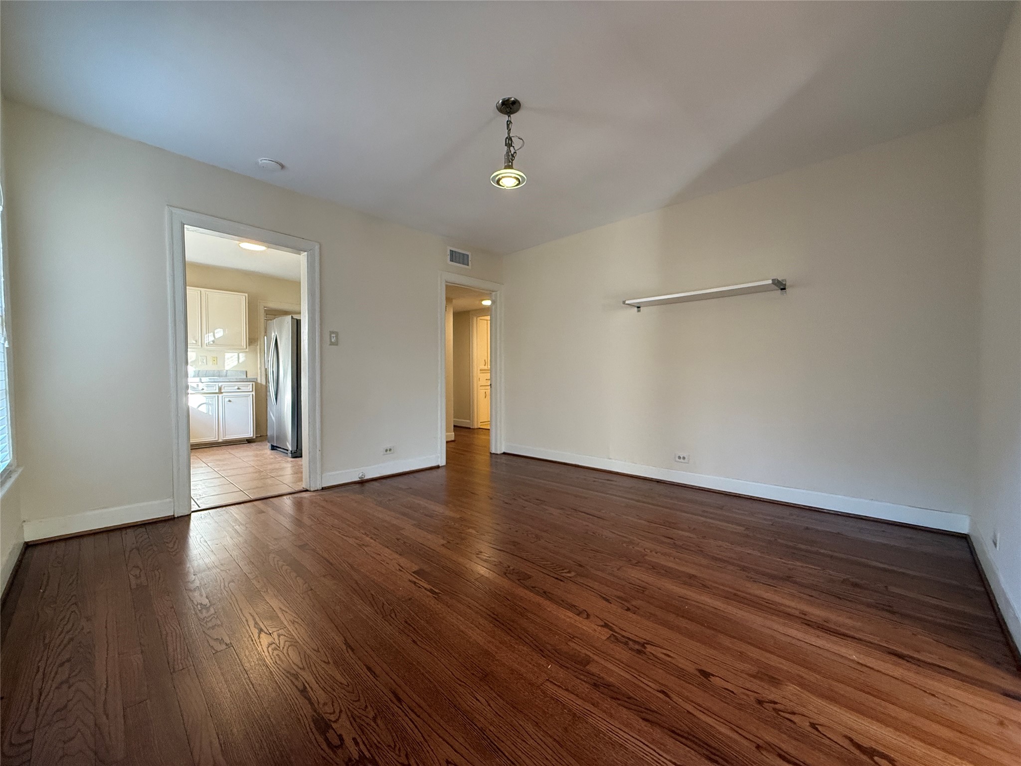 The beautiful hardwood flooring extends into the dining room and beyond to the hallway and bedrooms.