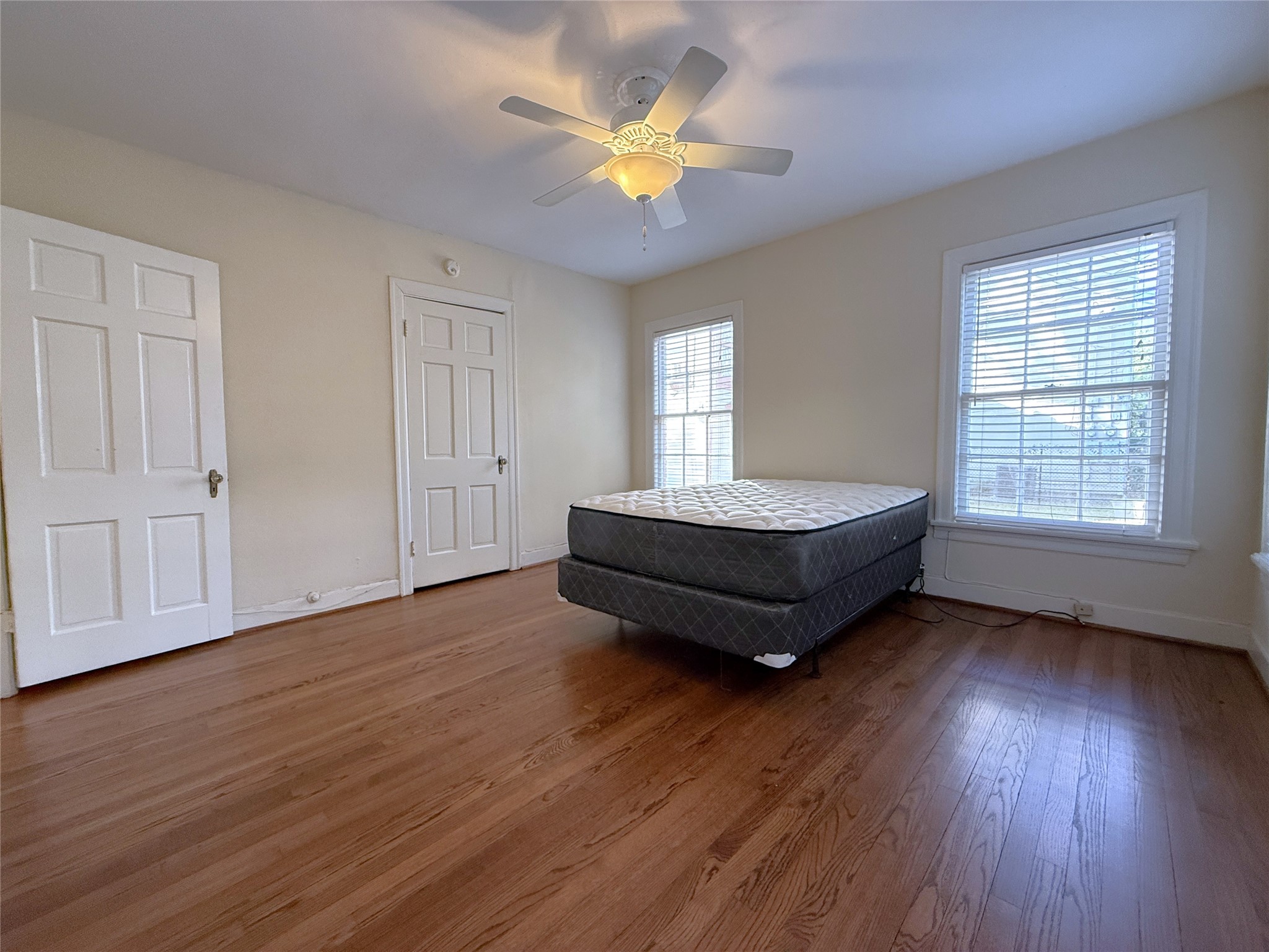 In the secondary bedroom, behind the closed door is a closet with double hanging bars