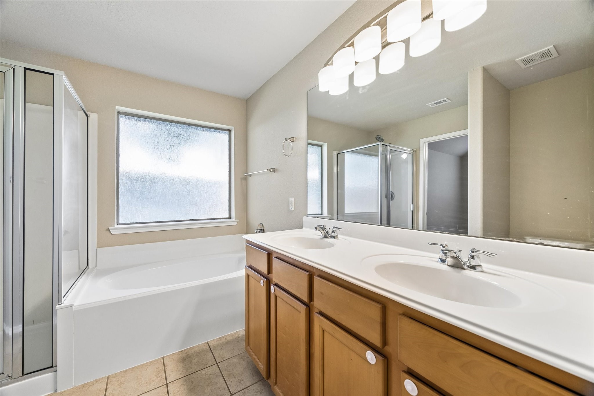 Enjoy a separate shower, soaking tub, and dual-sink vanity in the primary bathroom.