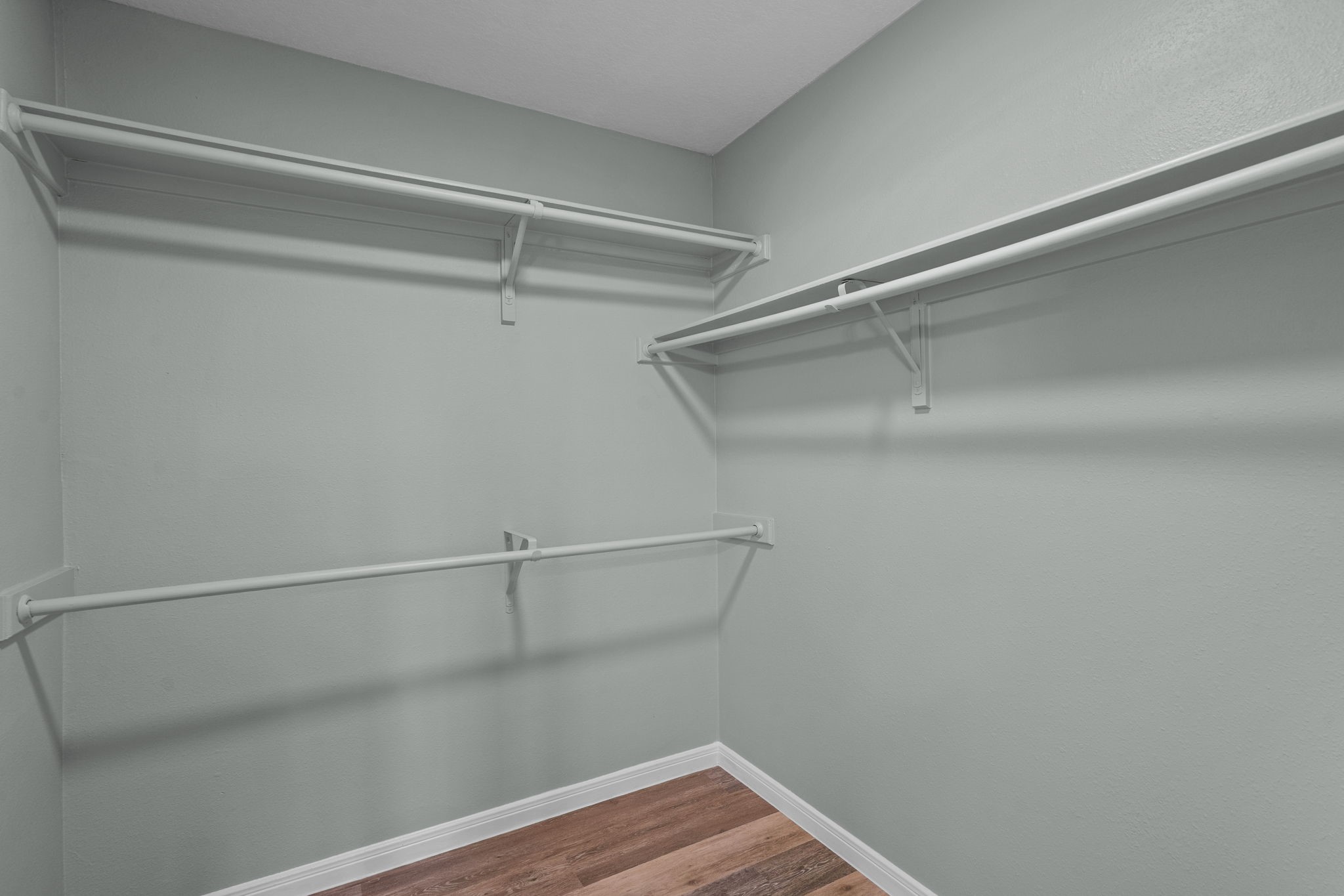 Spacious walk-in closet featuring ample hanging space and a sleek, modern design.