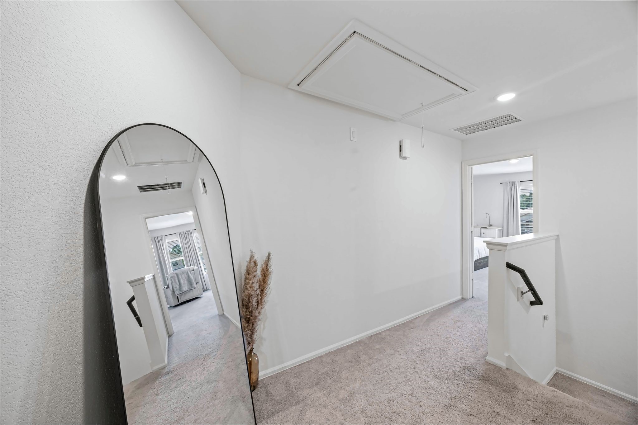 Upstairs landing with carpet and natural light