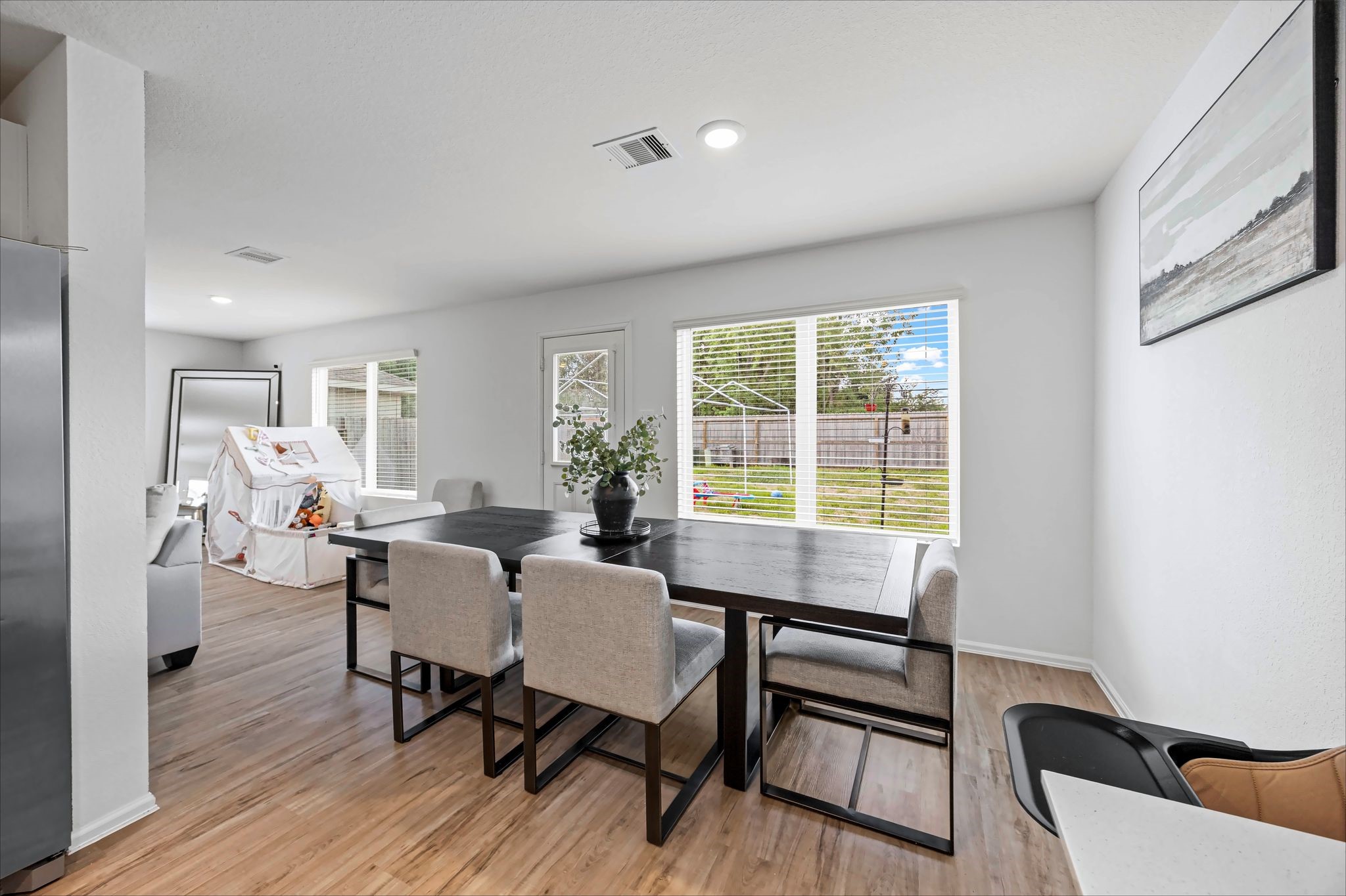 Dining area with big windows overlooking the backyard