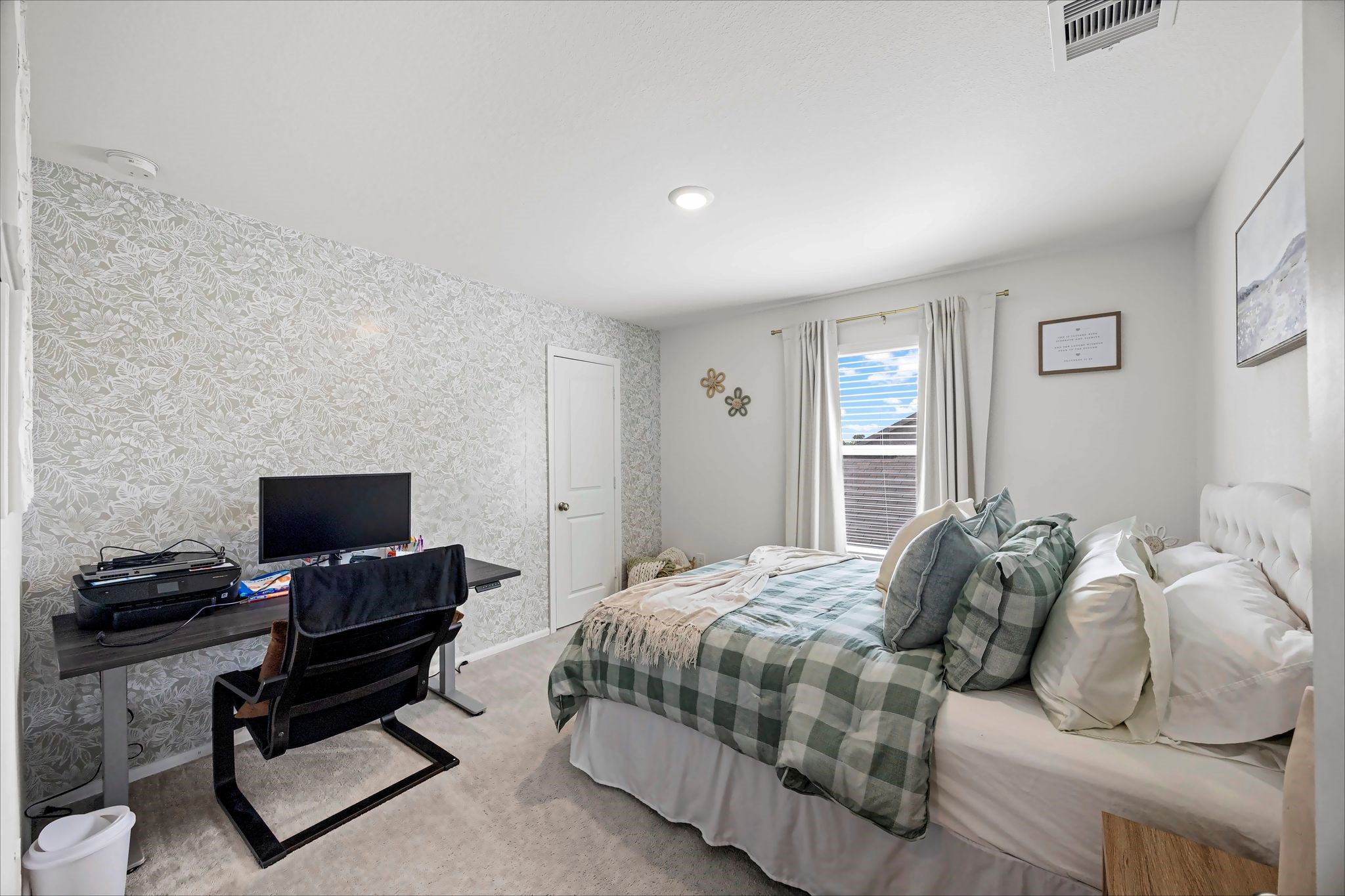 Secondary bedroom with space for a desk and an accent wall