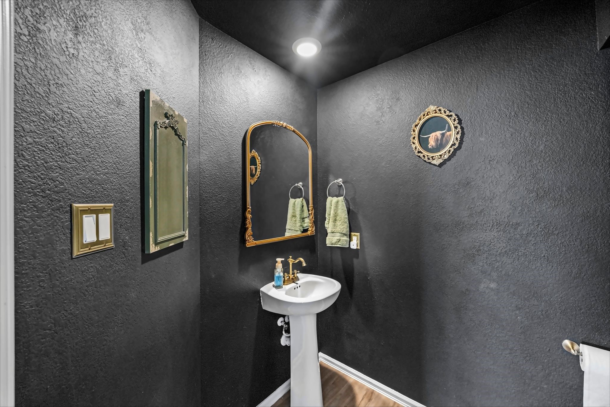 Downstairs half bath with a bold accent wall