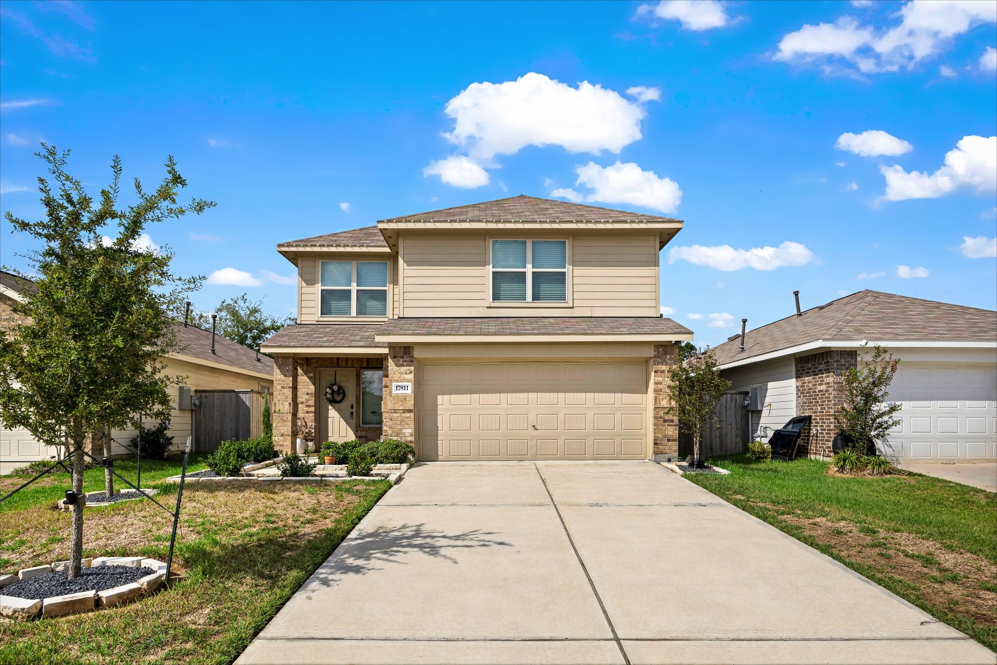 Two-story home with brick and siding accents and an attached 2-car garage