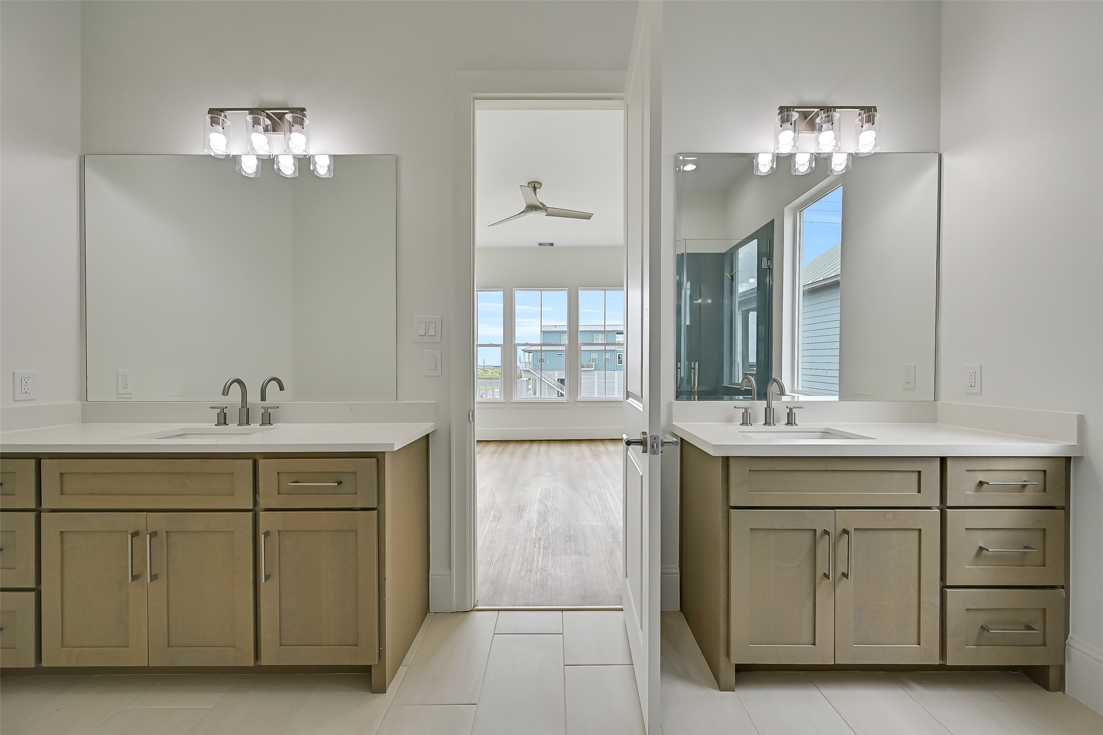 The primary bathroom features dual vanities and a spacious walk-in shower.