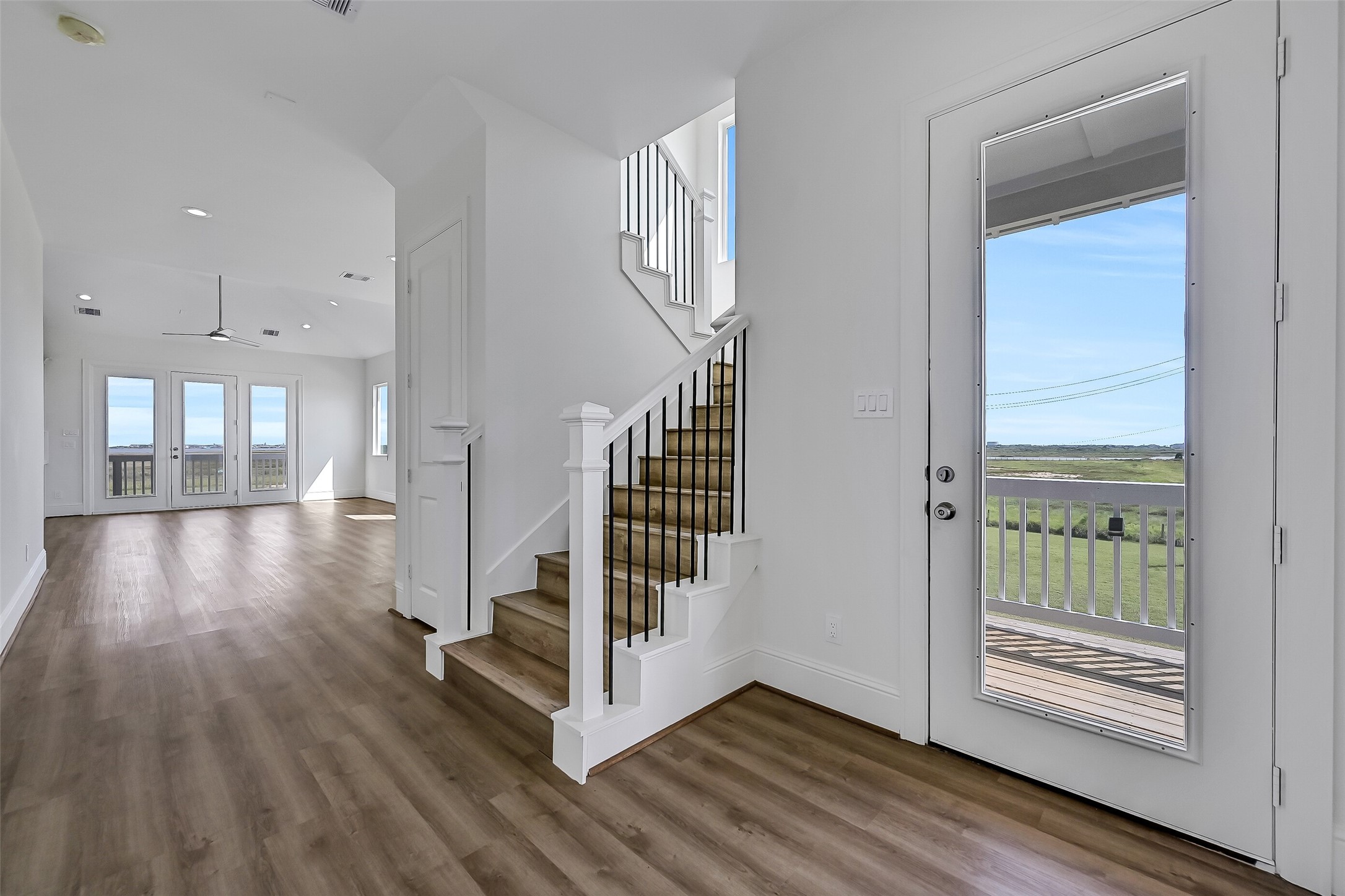 Soaring ceilings, walls of windows that fill the home with natural light, and beautiful vinyl plank flooring can be found throughout.