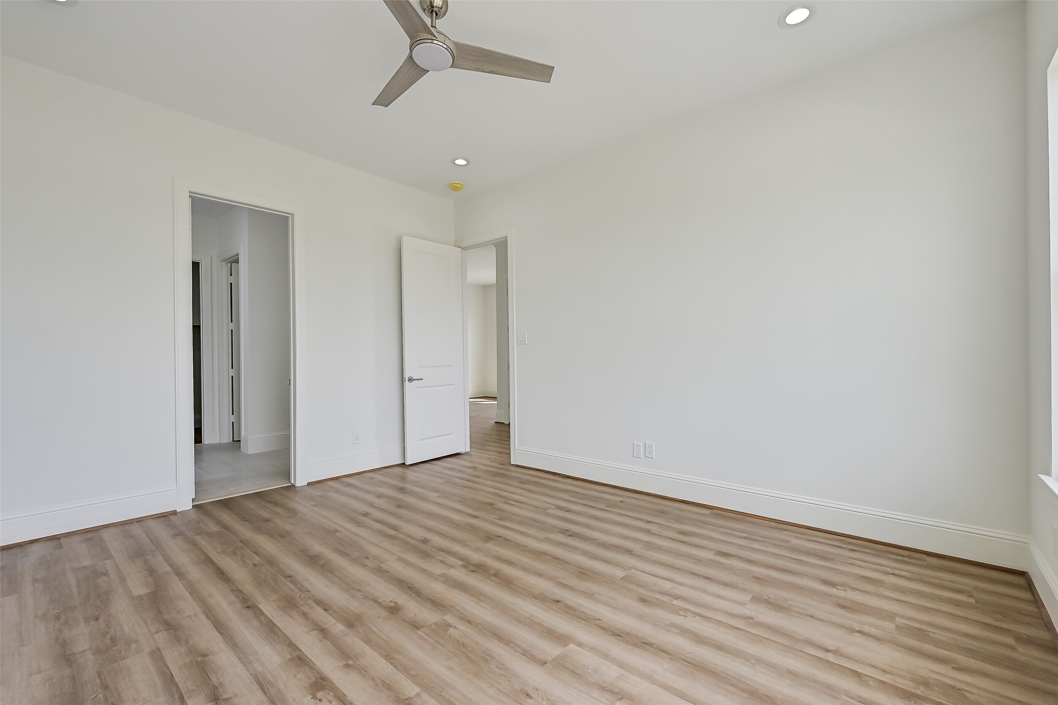 An additional view of the primary bedroom located on the main level.