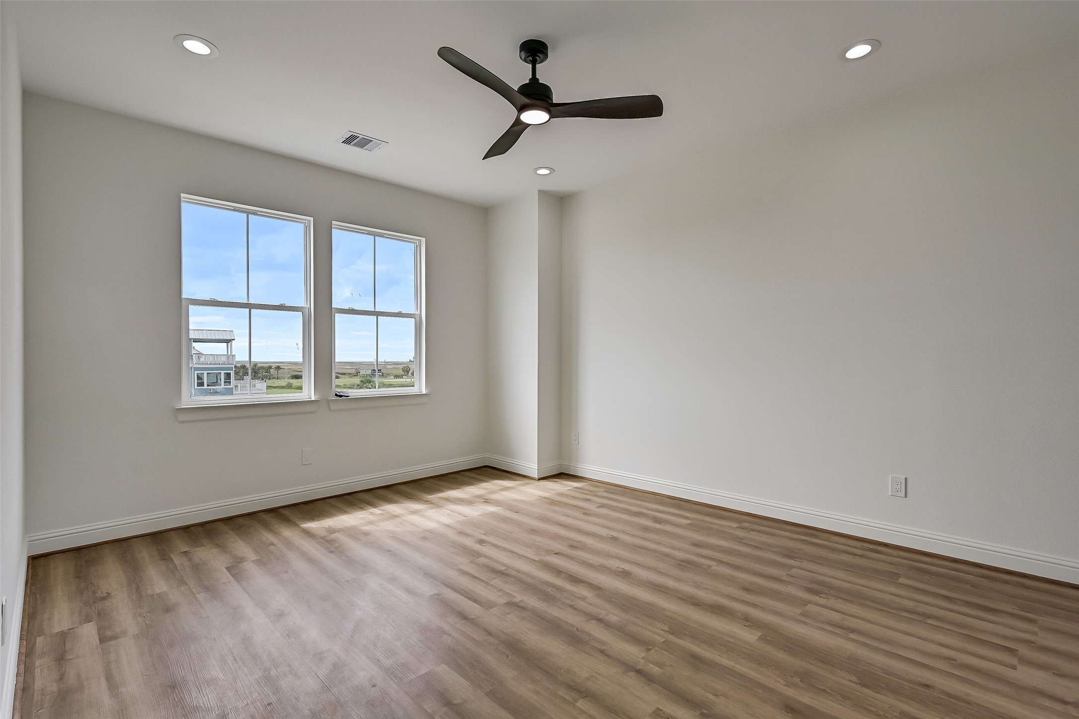 The first of two bedrooms on the upper level is this spacious guest bedroom, offering a comfortable and inviting retreat for family or visitors.