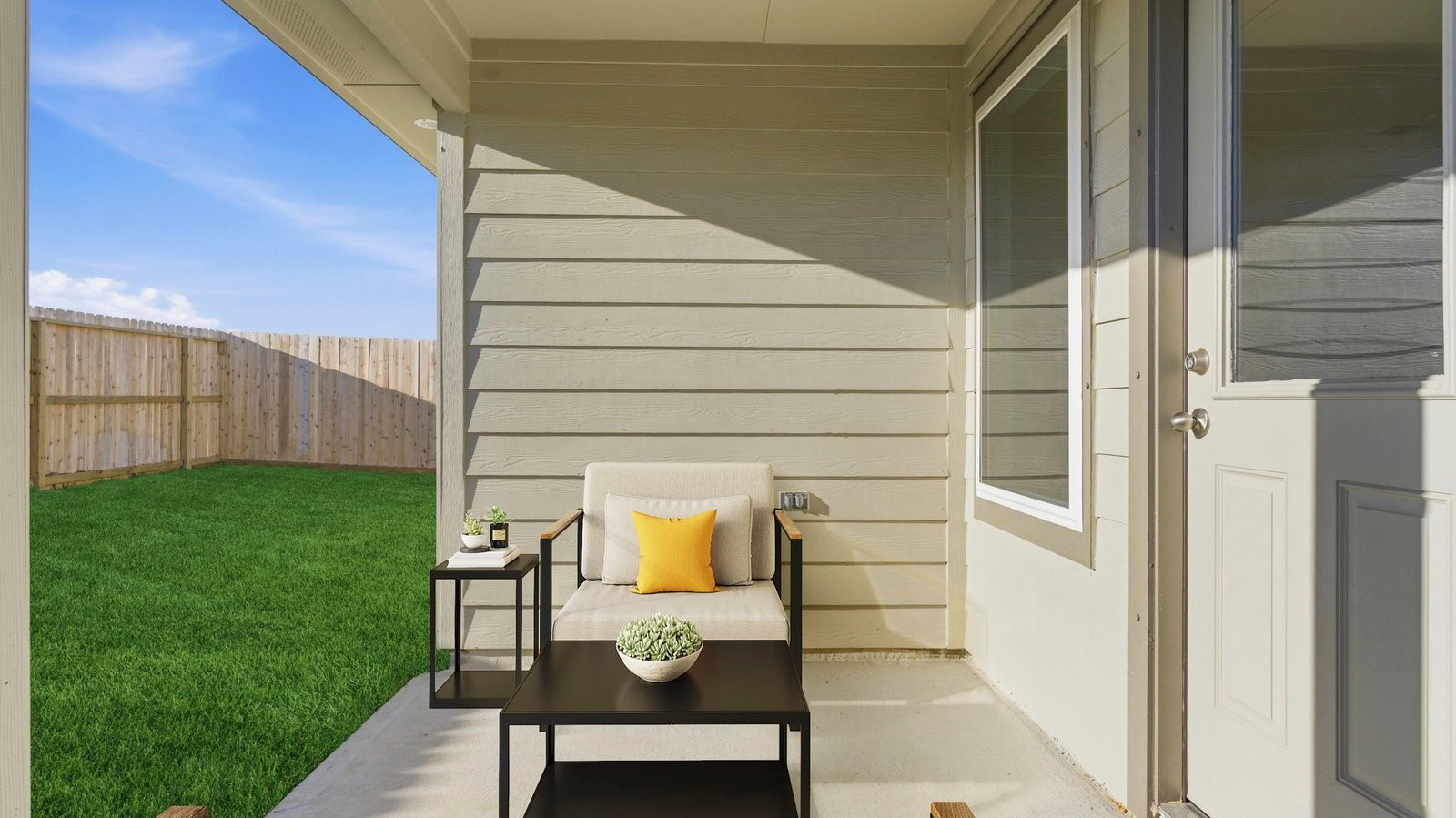 Outdoor covered patio with room for outdoor furniture to enjoy the backyard in those cooler months