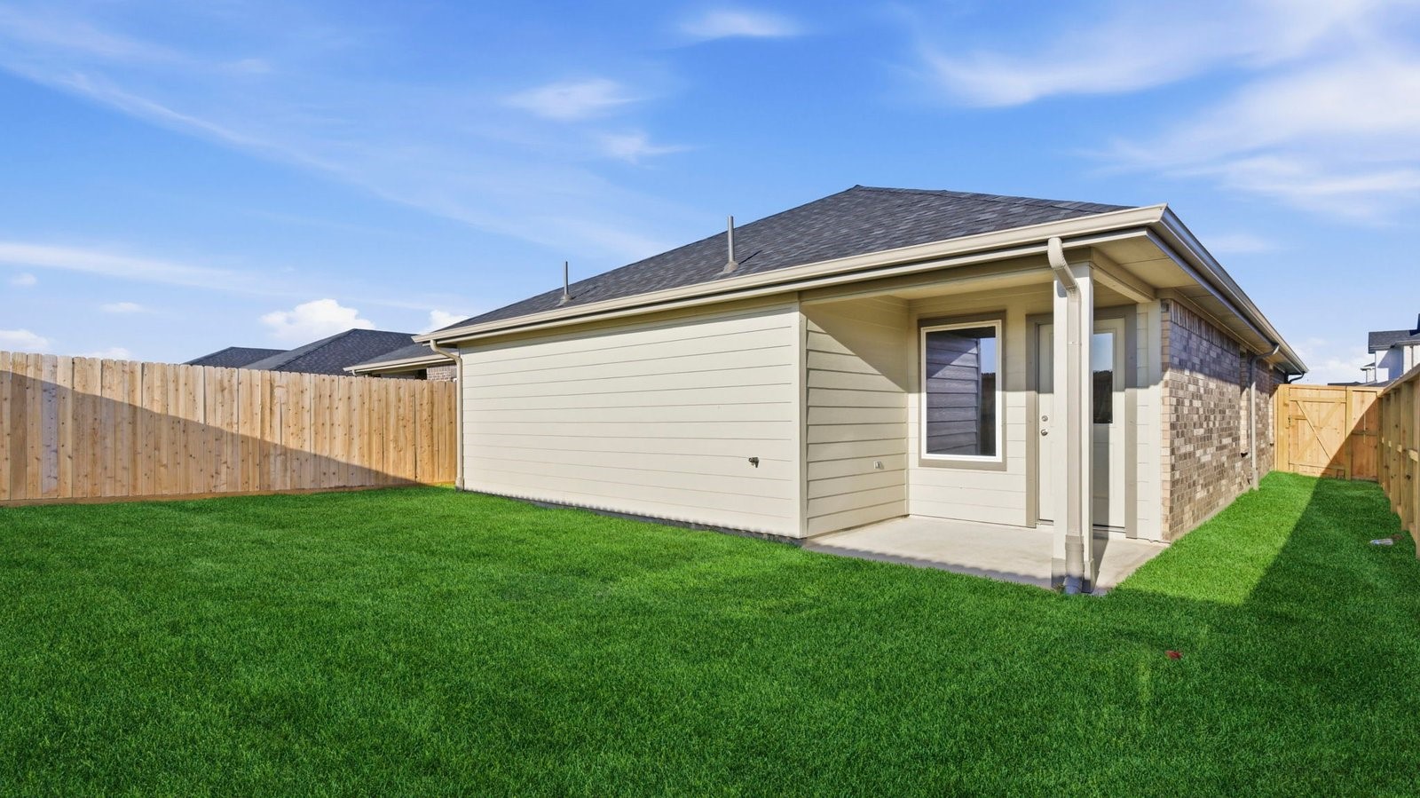 Large fenced-in backyard with a covered patio, perfect for outdoor entertaining.