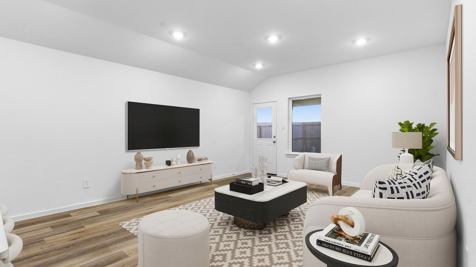 A well-organized living room that includes a kitchen and dining area, creating a warm and welcoming environment for gatherings.