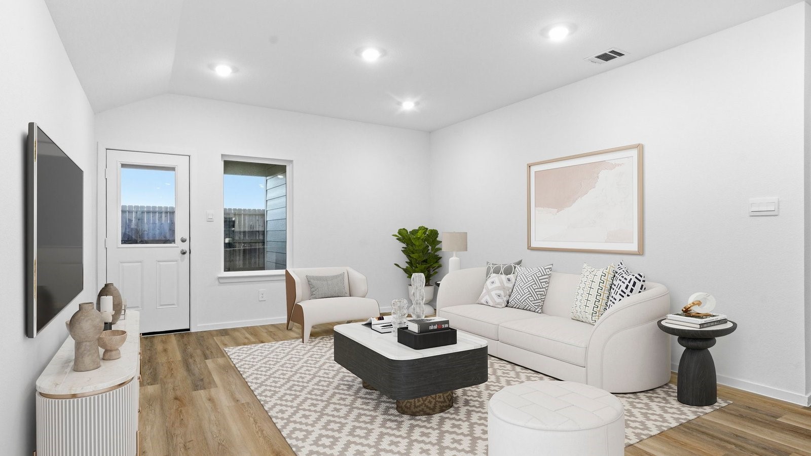 A cozy living room featuring a comfortable couch, a stylish coffee table, and an elegant painting on the wall.