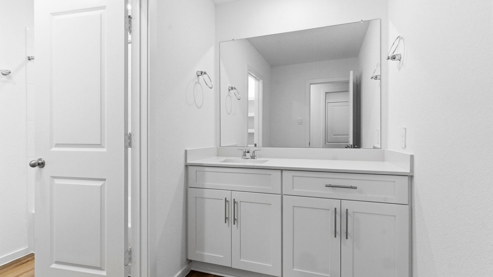 A well-designed bathroom equipped with quartz countertops, a standing tub, and a single vanity.