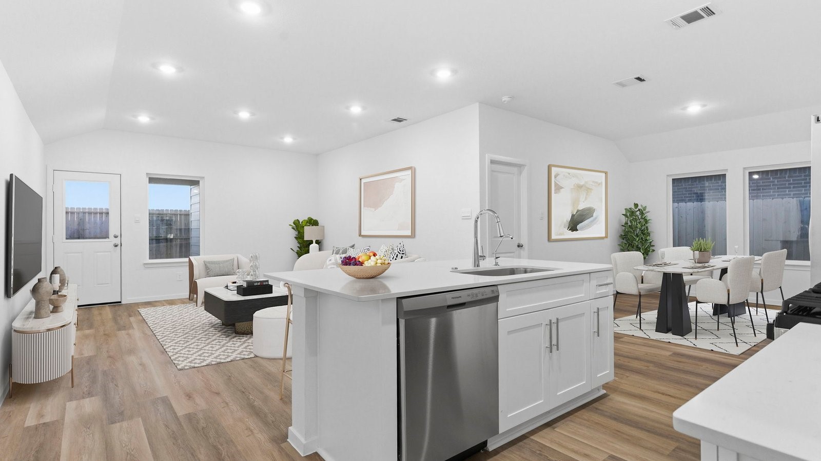 Kitchen adorned with painted cabinets seamlessly integrated into an open dining area layout.