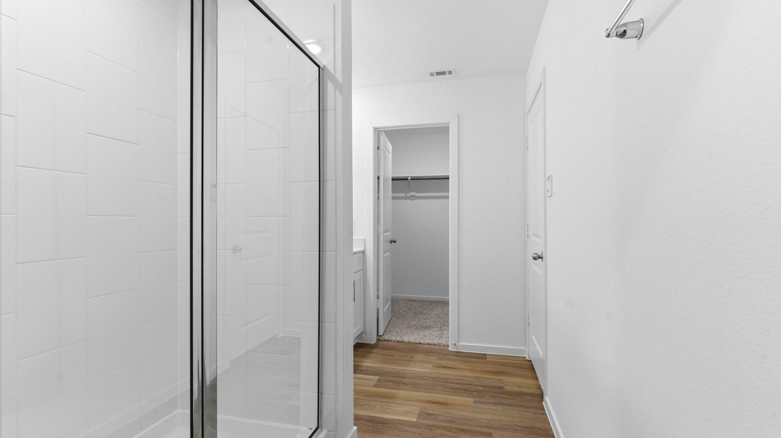 Primary bathroom with a glass-enclosed standing shower and separate soaking tub.