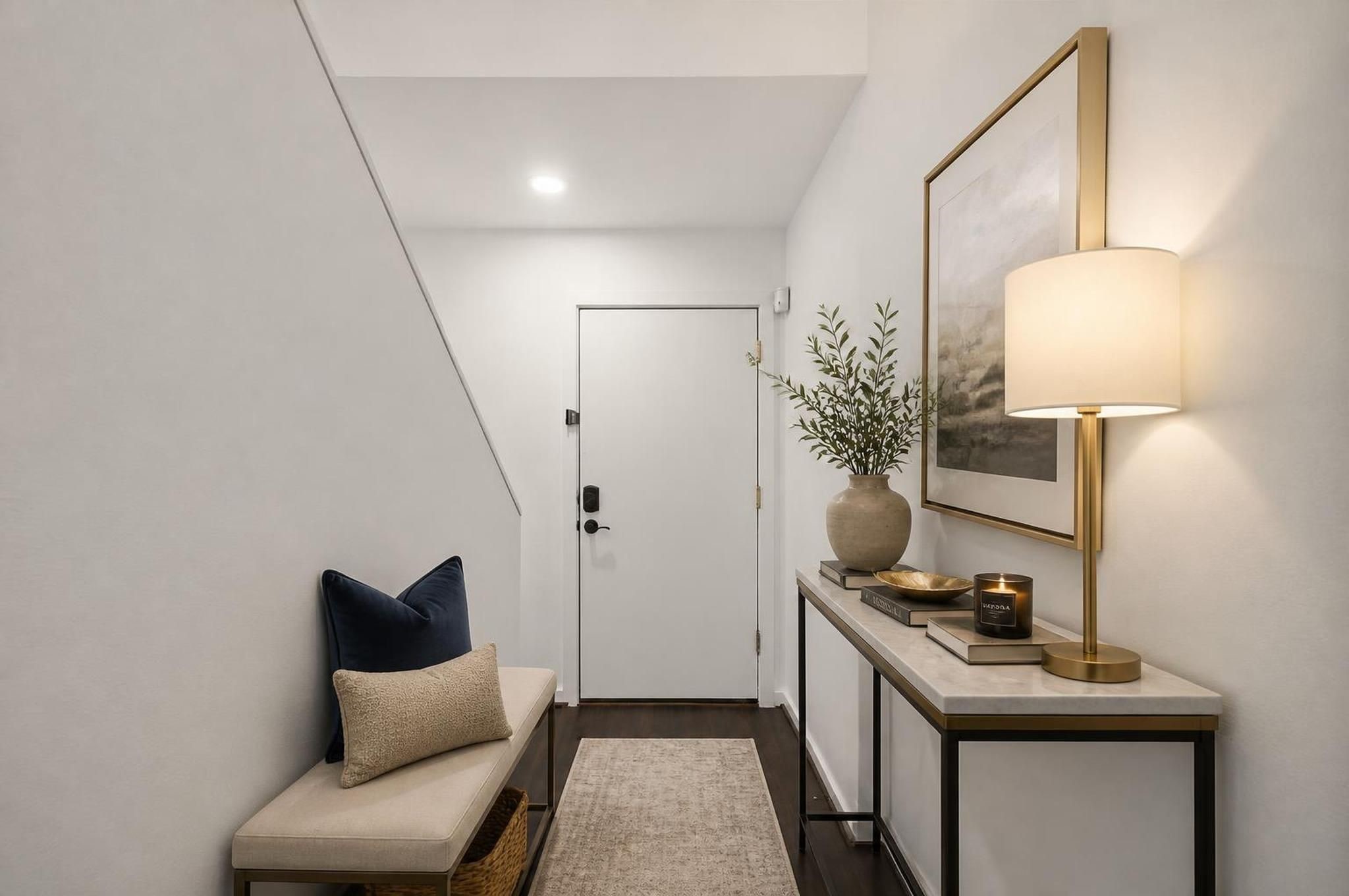 The entry introduces the home with a clean, functional first-floor layout and direct access to the private bedroom suite. Fresh interior paint and refreshed concrete floors give this level a crisp, updated feel. Virtually staged. The entry introduces the home with a clean, functional first-floor layout and direct access to the private bedroom suite. Fresh interior paint and refreshed concrete floors give this level a crisp, updated feel. Virtually staged.