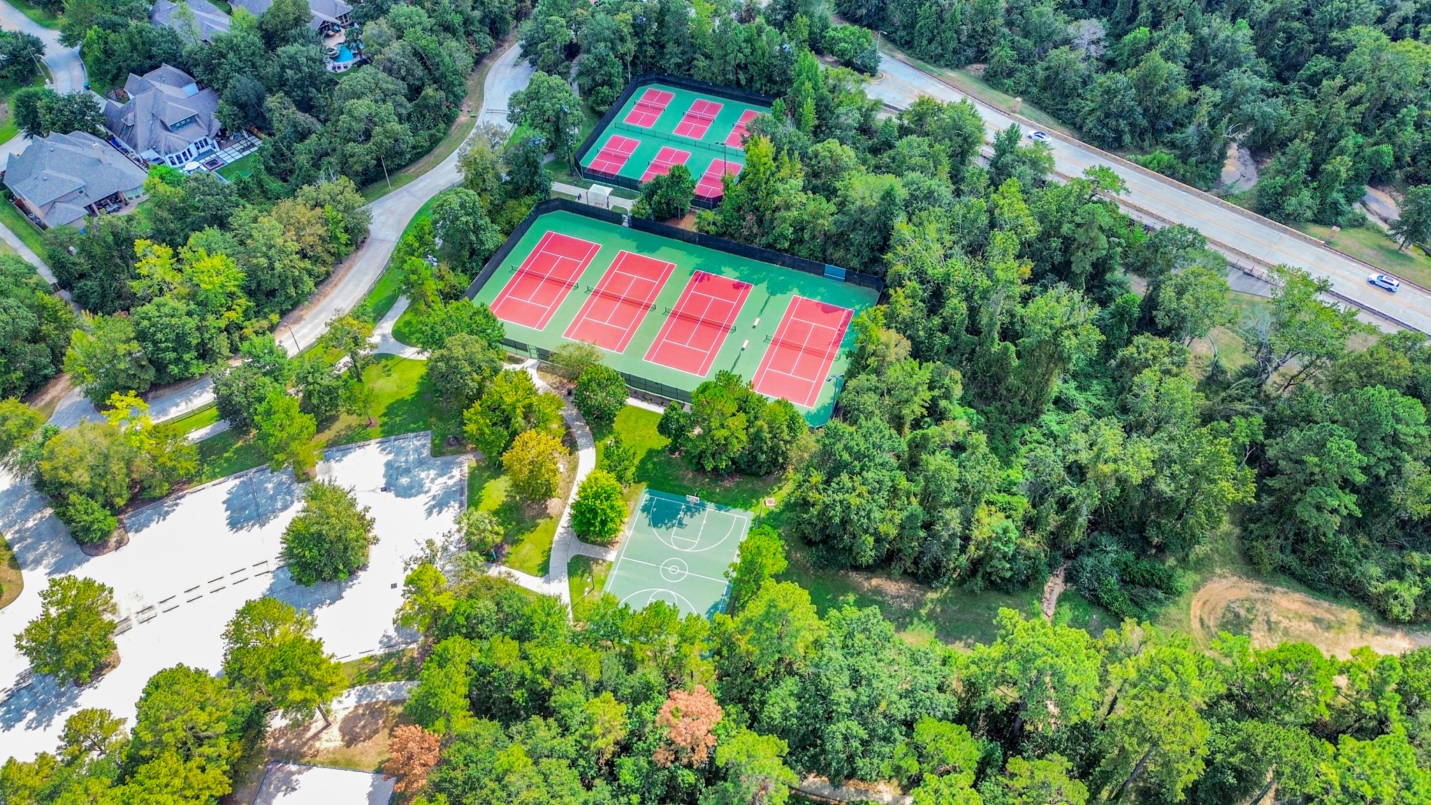 Surrounded by lush greenery, this property boasts easy access to a vibrant sports complex featuring multiple tennis courts and a basketball court, ideal for active lifestyles.