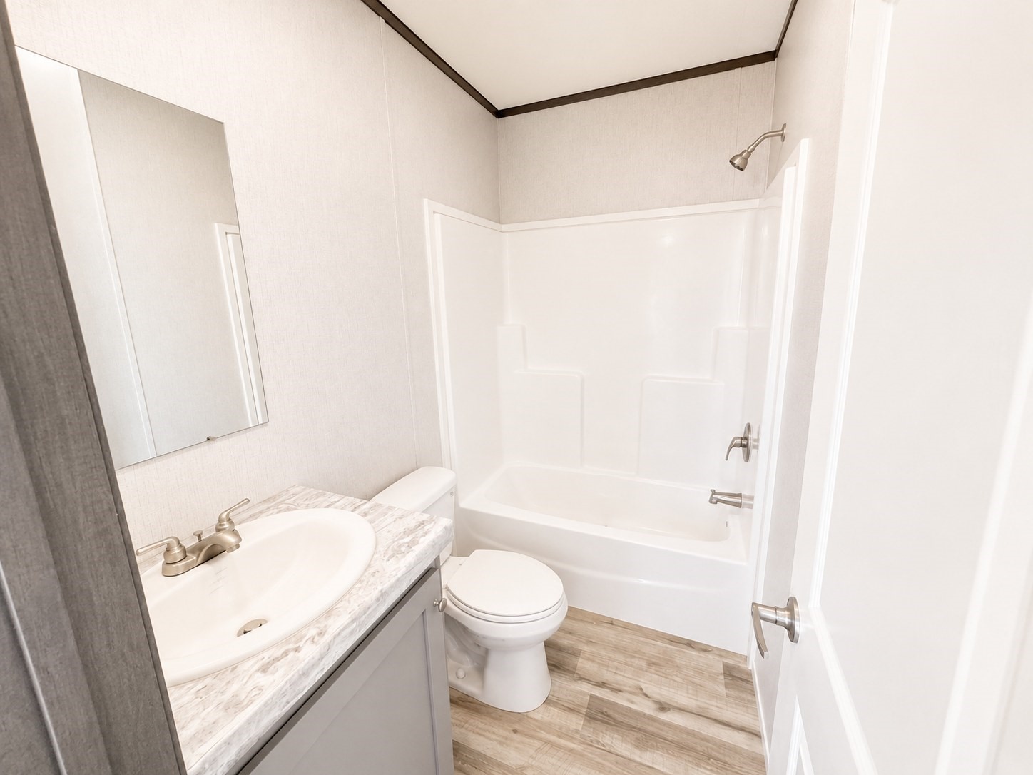 Enjoy comfort and convenience in this beautifully designed bathroom! Featuring a stylish vanity with ample countertop space, modern fixtures, a spacious bathtub and shower combination, and elegant finishes, this inviting space offers the perfect blend of style and functionality.