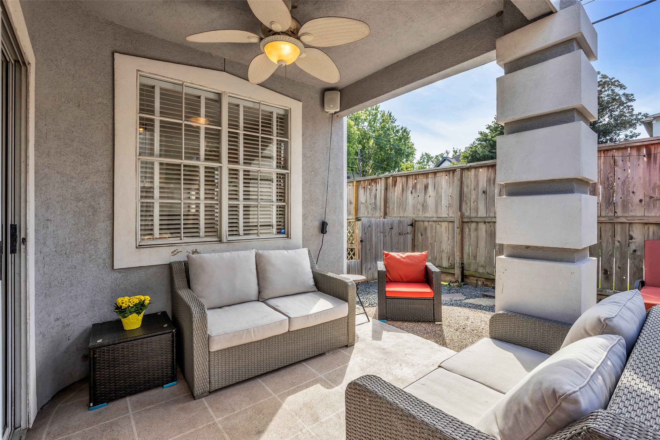 Covered patio with an outdoor speaker, which is included in the lease.