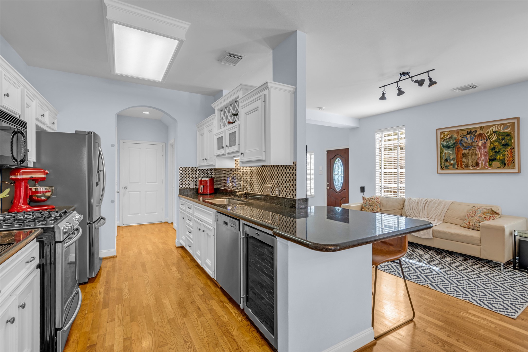Stainless steel appliances in the kitchen, including a wine fridge. The refigerator is also included.
