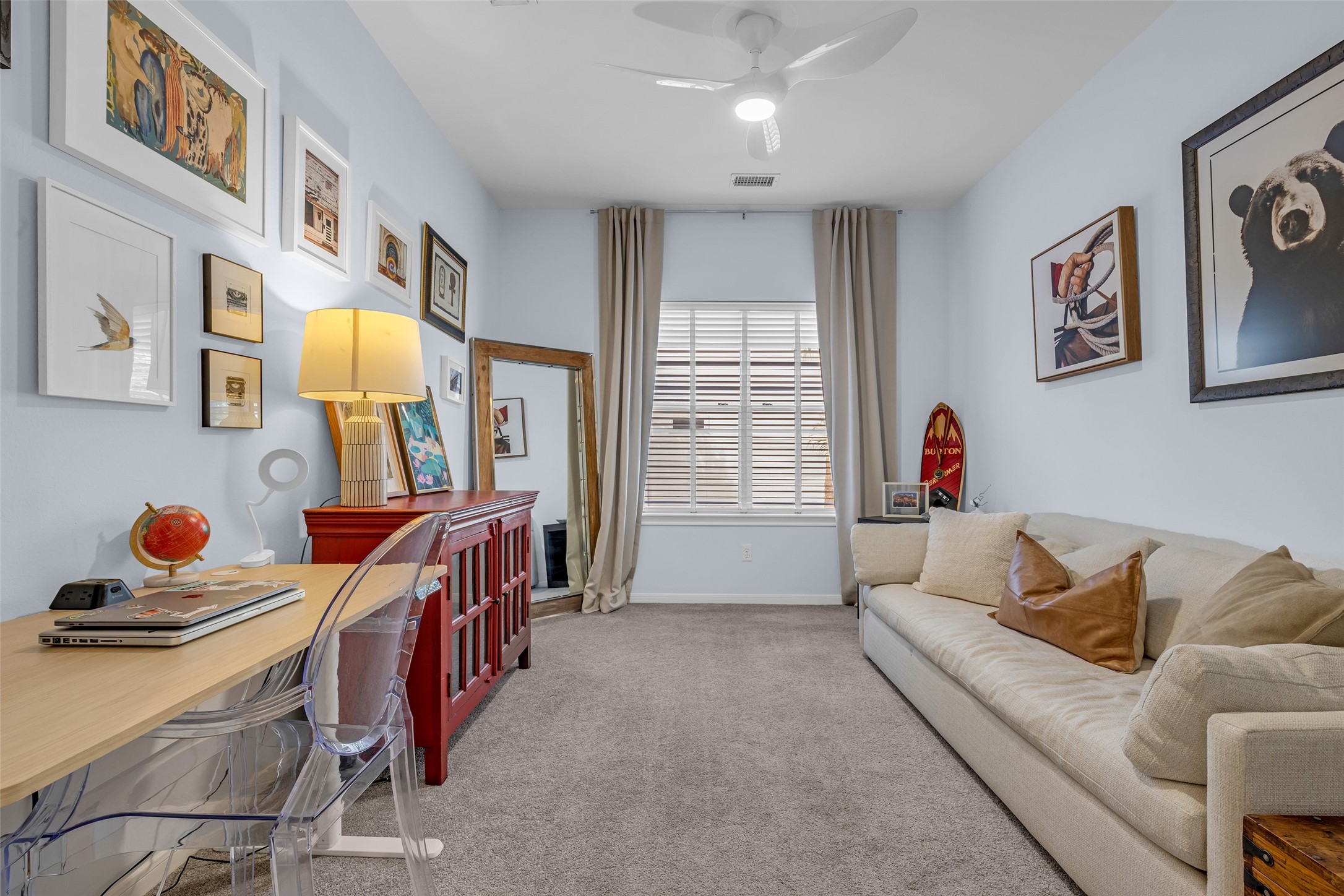 One of two secondary bedrooms, with a closet and a ceiling fan.