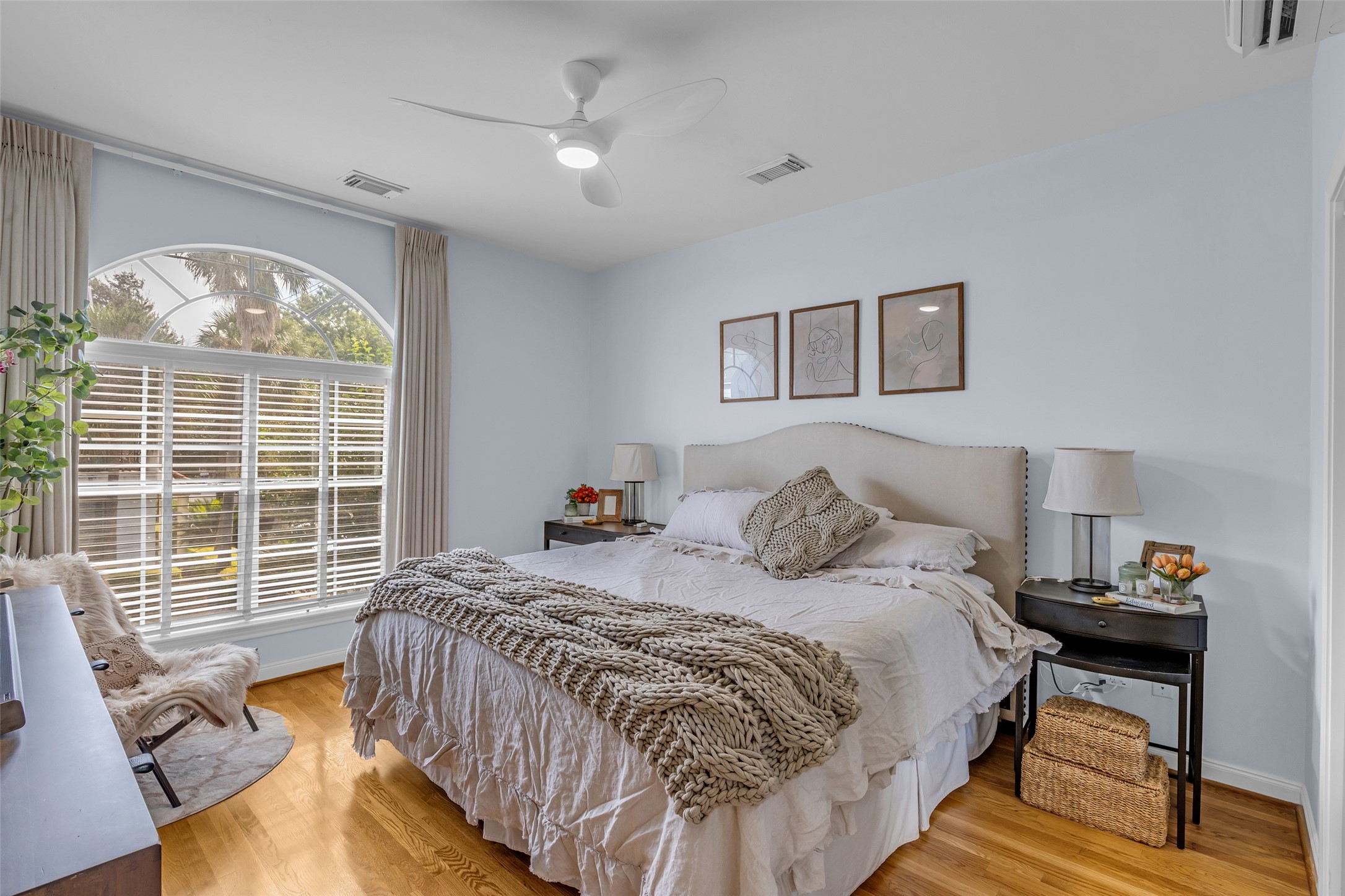 The primary bedroom with hardwood flooring.