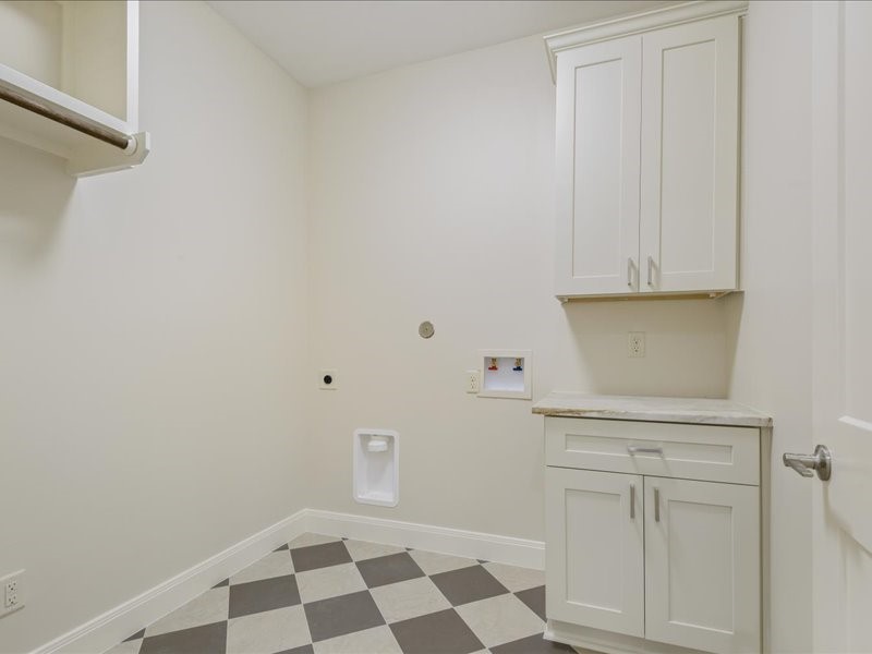 Spacious utility room is large enough for refrigerator/freezer