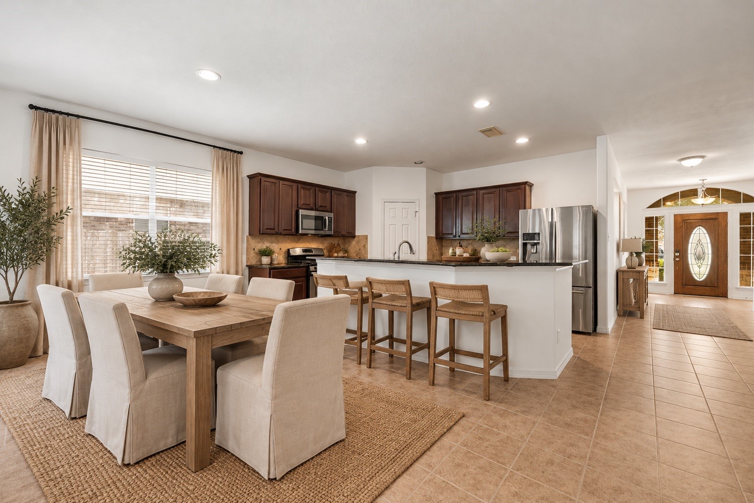 Virtual staging showcases how the kitchen can accommodate a coordinated dining and cooking setup, highlighting its role as a natural gathering point within the open living area.