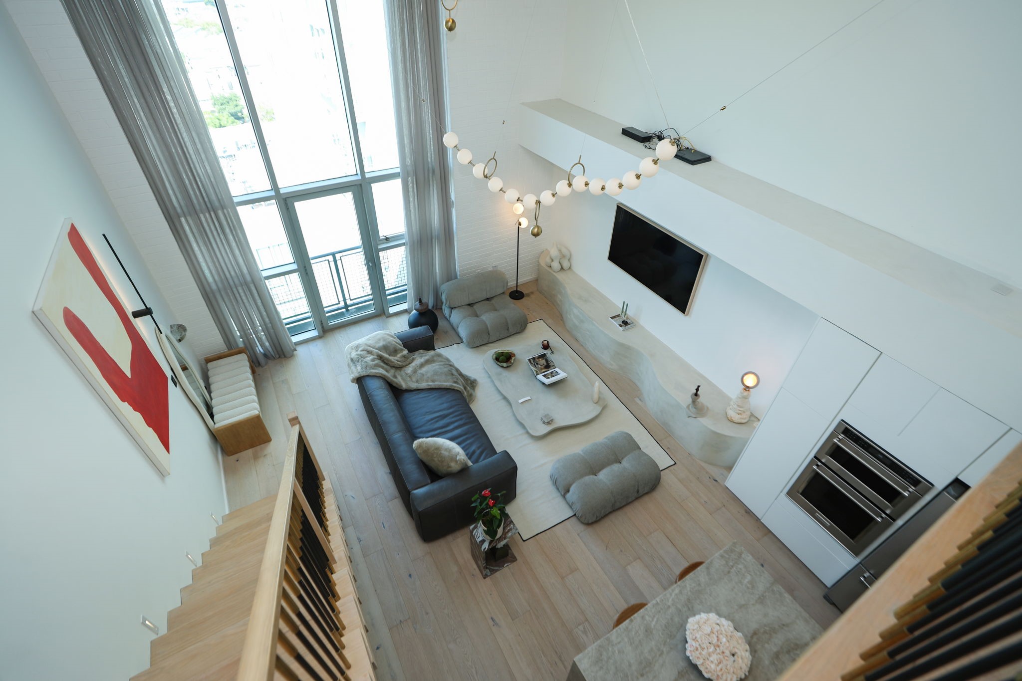 Soaring 18 foot ceilings and floor to ceiling windows highlight this dramatic lofts industrial character.