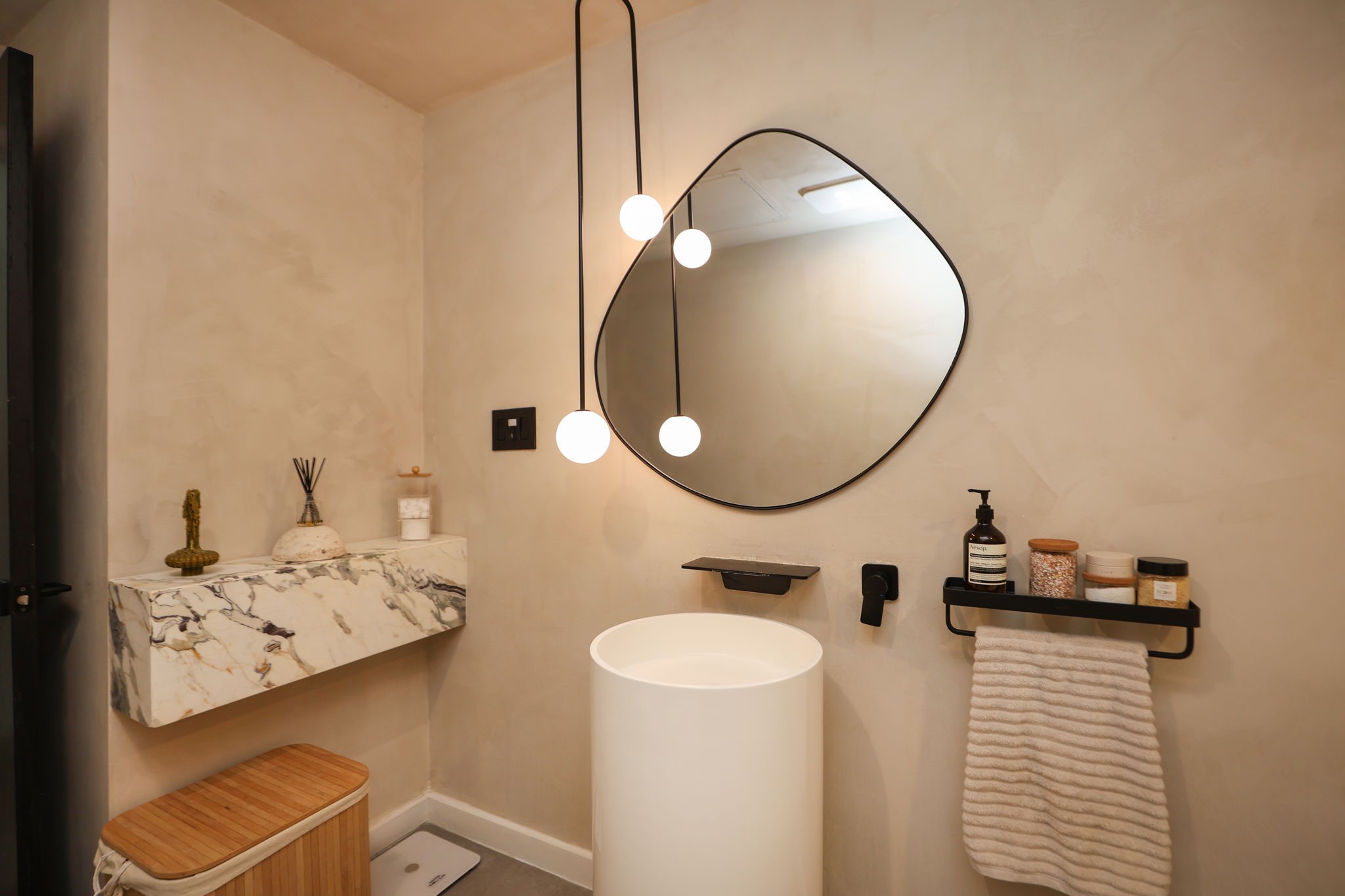 Calacatta Viola marble accents, pendent lighting, and modern fixtures create a sophisticated powder bath.