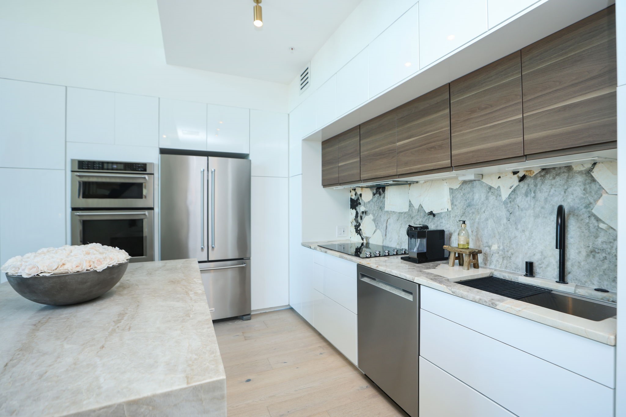 Cook with ease in this functional kitchen featuring KitchenAid stainless steel appliances and abundant self-closing cabinetry. Also available are Air fryer, Nespresso and flatware also included.