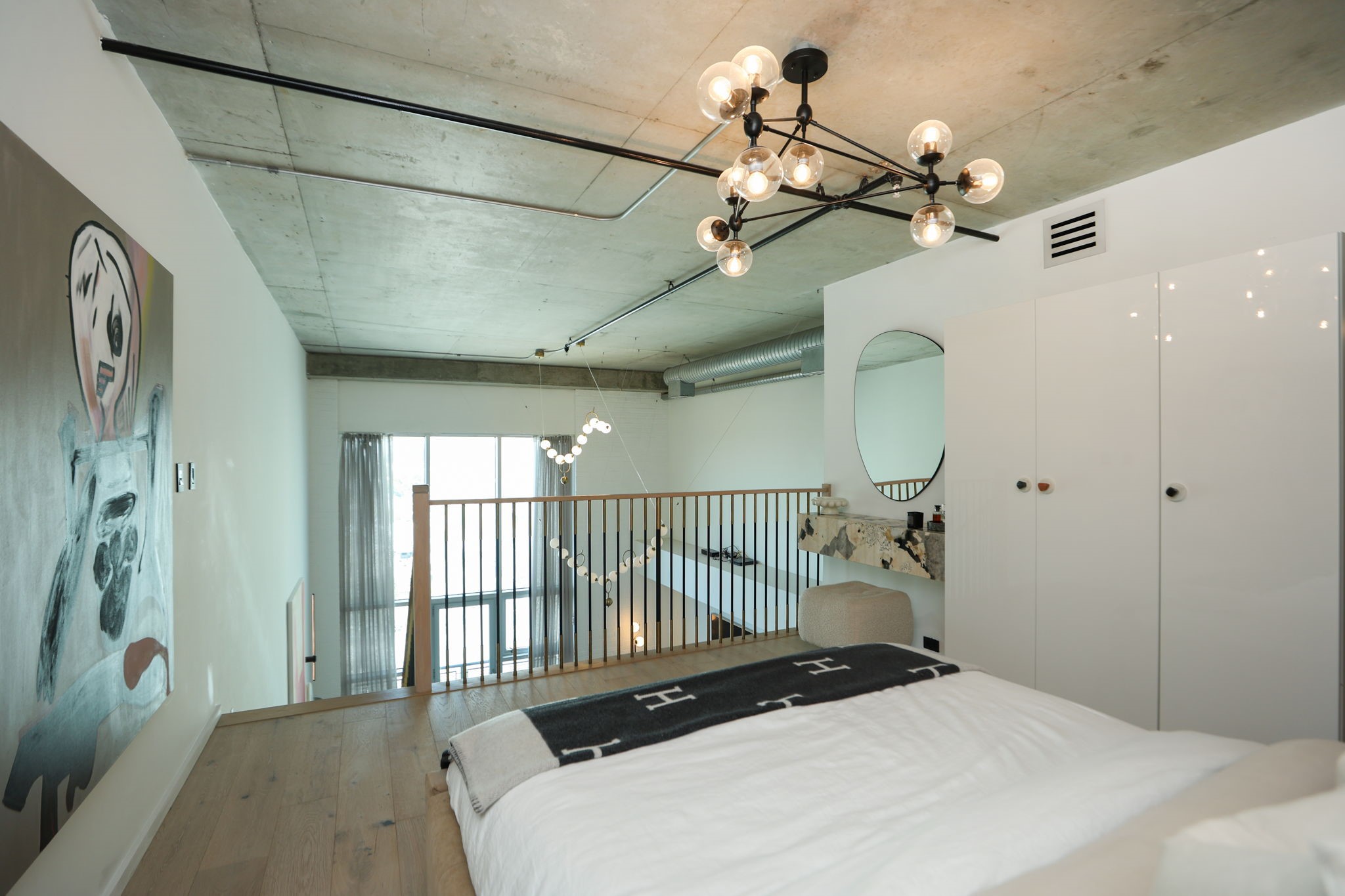 Elevated primary suite overlooking first floor living space.