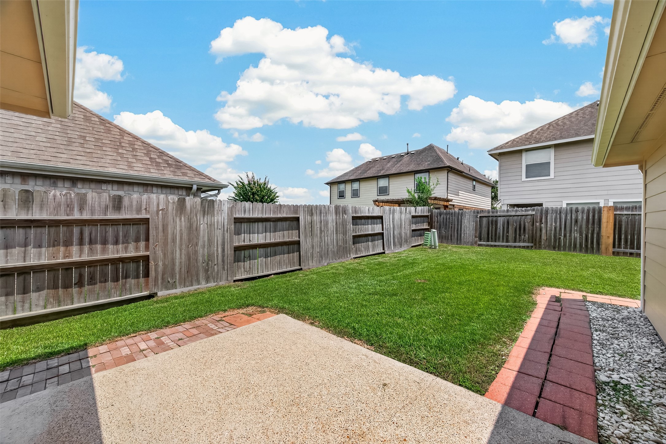 Rear Patio Space with walkway to the storage building