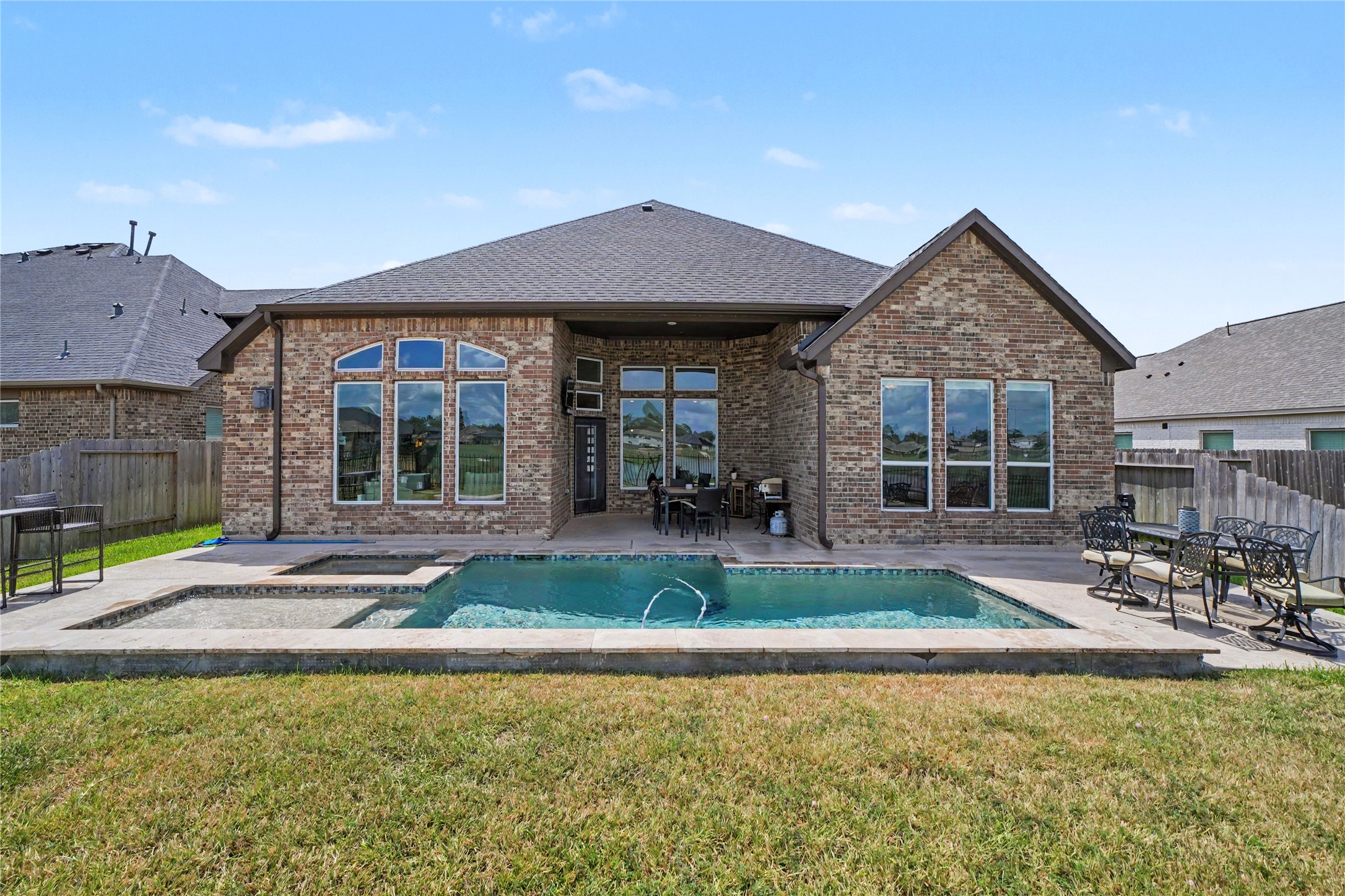 Dive into relaxation with your amazing pool, perfectly complementing this charming brick home, ideal for entertaining and unwinding.