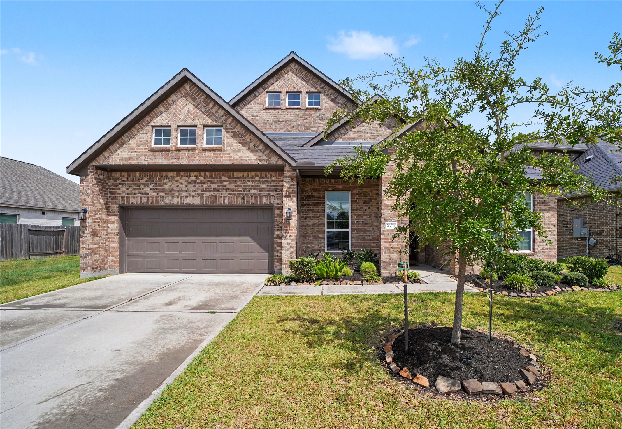 Charming brick home with a spacious two-car garage, manicured landscaping, and a welcoming front porch. Charming brick home with a spacious two-car garage, manicured landscaping, and a welcoming front porch.