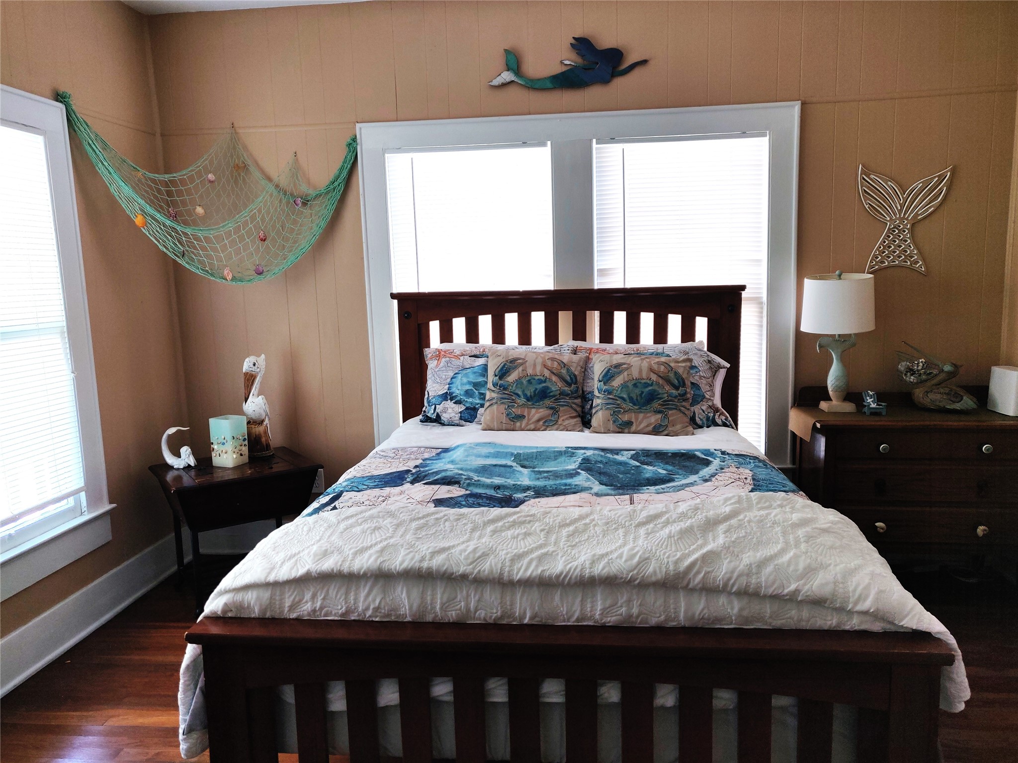 Bright and airy third bedroom, ideal for families or friends, complete with coastal decor and ample storage