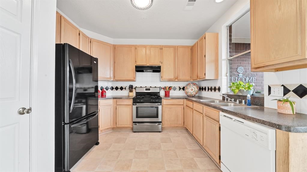 The kitchen offers 42-inch cabinets, ample counter space, a gas range, refrigerator, and dishwasher.