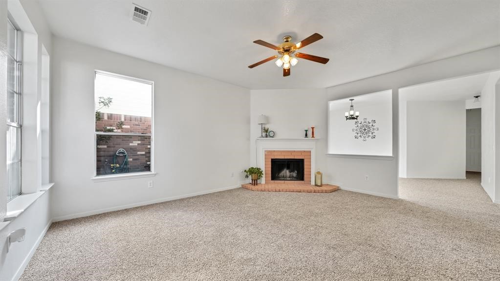 The inviting living room features a cozy fireplace and flows into a formal dining room and separate breakfast area.