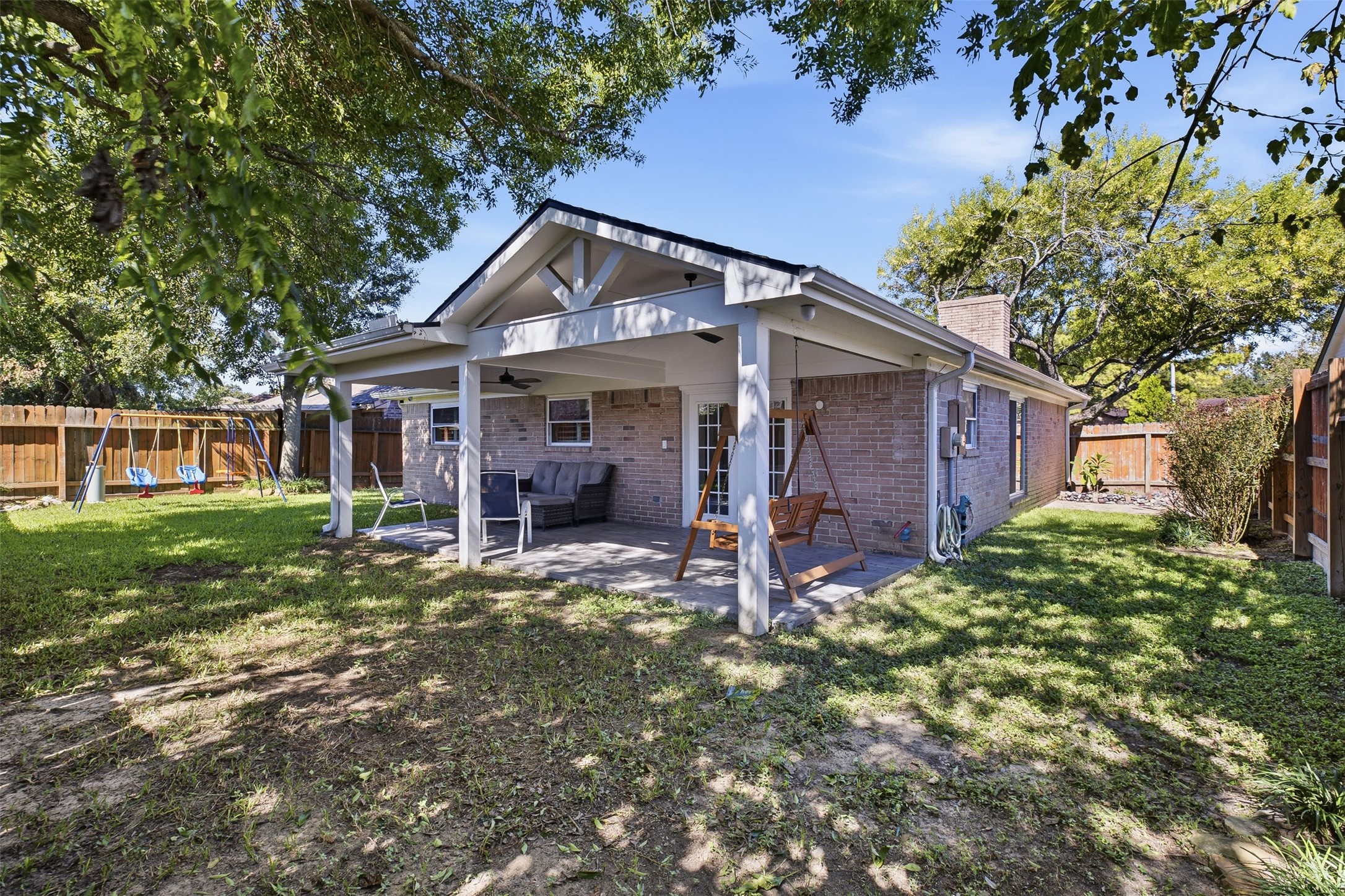 Step outside to a spacious covered patio overlooking the fenced backyard and mature shade treesan inviting setting for relaxing, entertaining, or enjoying outdoor dining year-round.