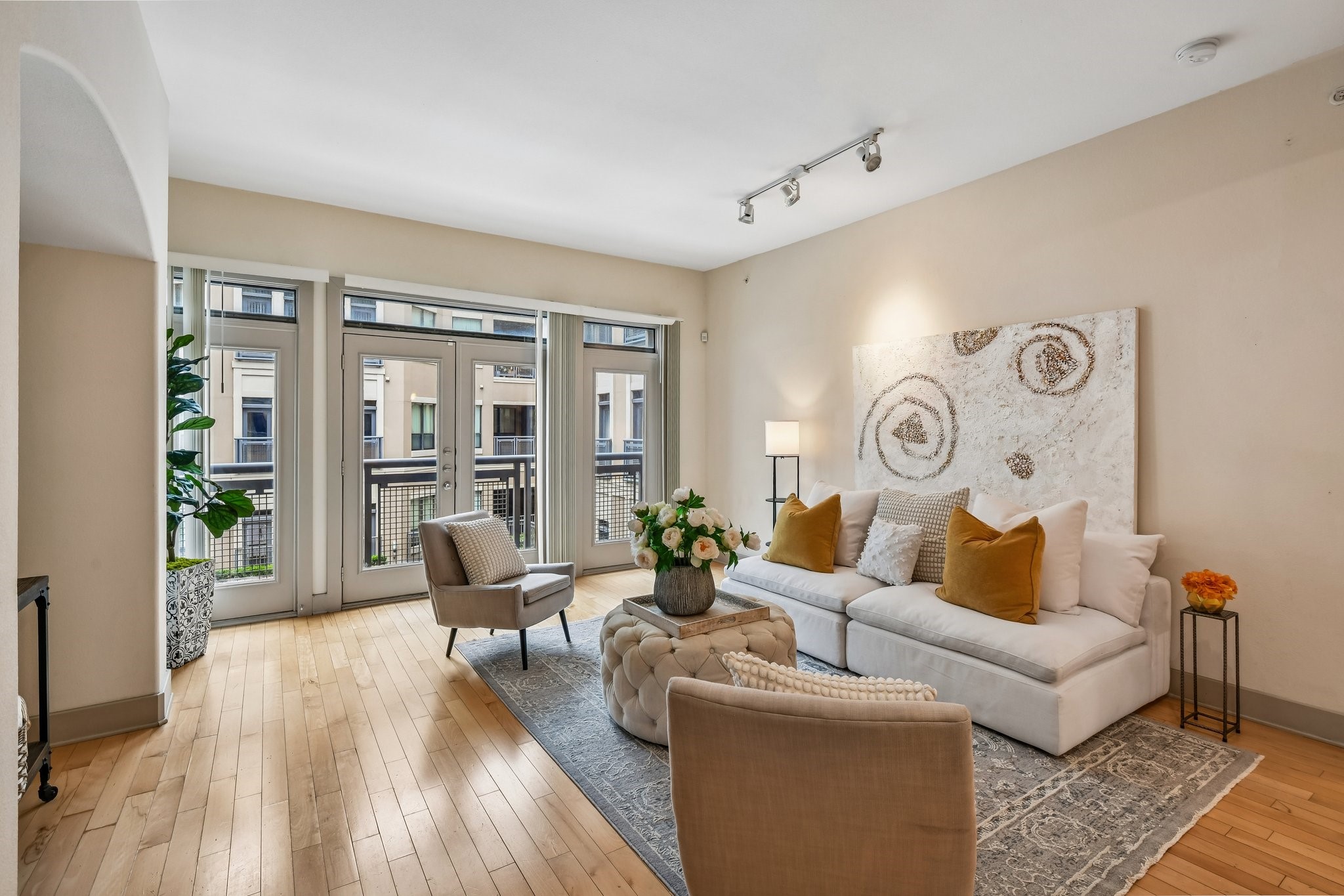 Two large windows and doors provide plenty of natural light in the living room